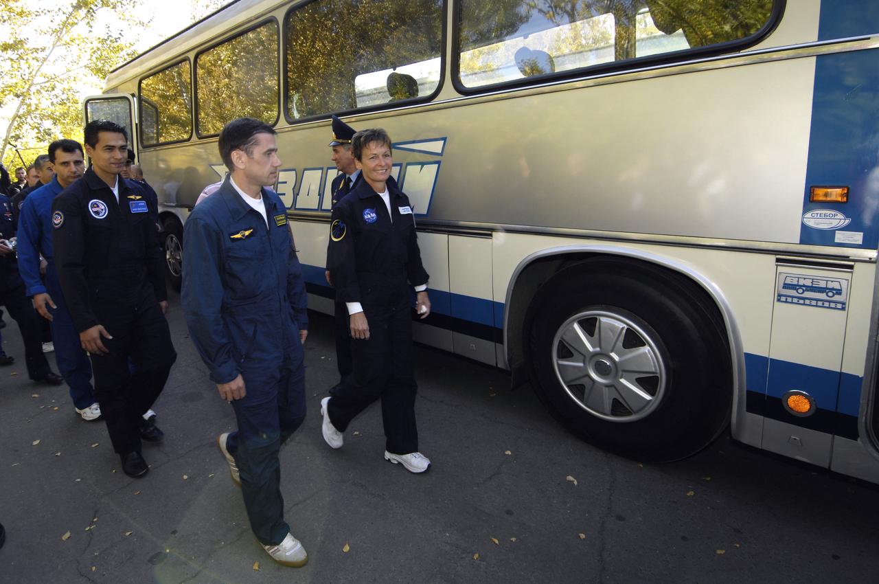 Expedition 16 Commander Peggy Whitson, right, Flight Engineer and Soyuz Commander Yuri Malenchenko and Malaysian spaceflight participant Sheikh Muszhaphar Shukor, left, board the crew bus that will take them from the Cosmonaut hotel to building 254 where they will don their flight suits at the Baikonur Cosmodrome in Kazakhstan, Wednesday, Oct. 10, 2007. The crew launched at sunset in their Soyuz TMA-11 spacecraft bound for a docking to the International Space Station on Oct. 12. Whitson and Malenchenko will spend six months on the station, while Shukor will return to Earth Oct. 21 with two of the Expedition 15 crewmembers currently on the complex. Photo Credit: (NASA/Bill Ingalls)