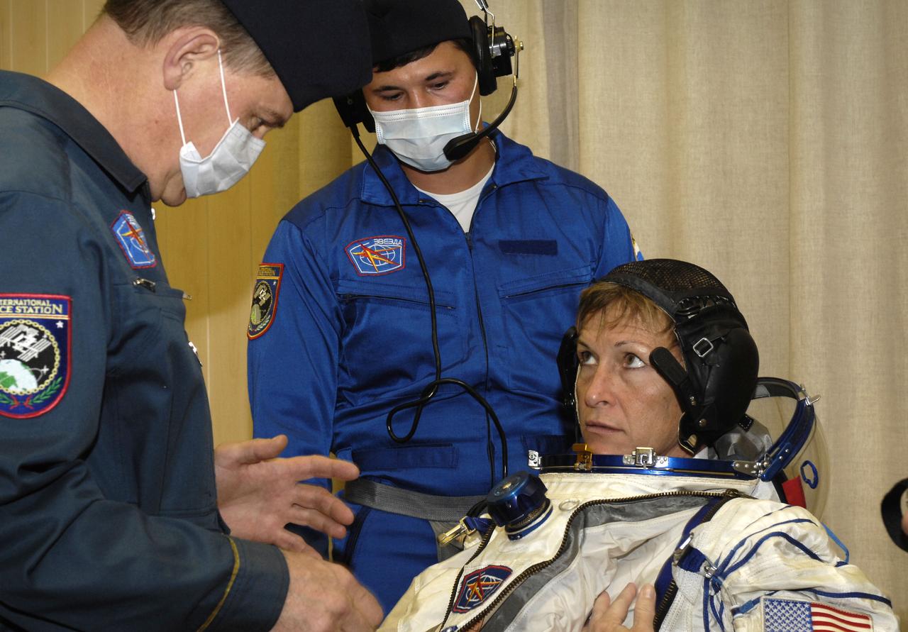 Expedition 16 Commander Peggy Whitson dons her flight suit prior to launch, Wednesday, Oct. 10, 2007, in Baikonur, Kazakhstan. Expedition 16 Flight Engineer and Soyuz Commander Yuri Malenchenko, Whitson, and Malaysian spaceflight participant Sheikh Muszaphar Shukor launched from the Baikonur Cosmodrome in Kazakhstan at sunset n their Soyuz TMA-11 spacecraft bound for a docking to the International Space Station on Oct. 12. Whitson and Malenchenko will spend six months on the station, while Shukor will return to Earth Oct. 21 with two of the Expedition 15 crewmembers currently on the complex. Photo Credit: (NASA/Bill Ingalls)
