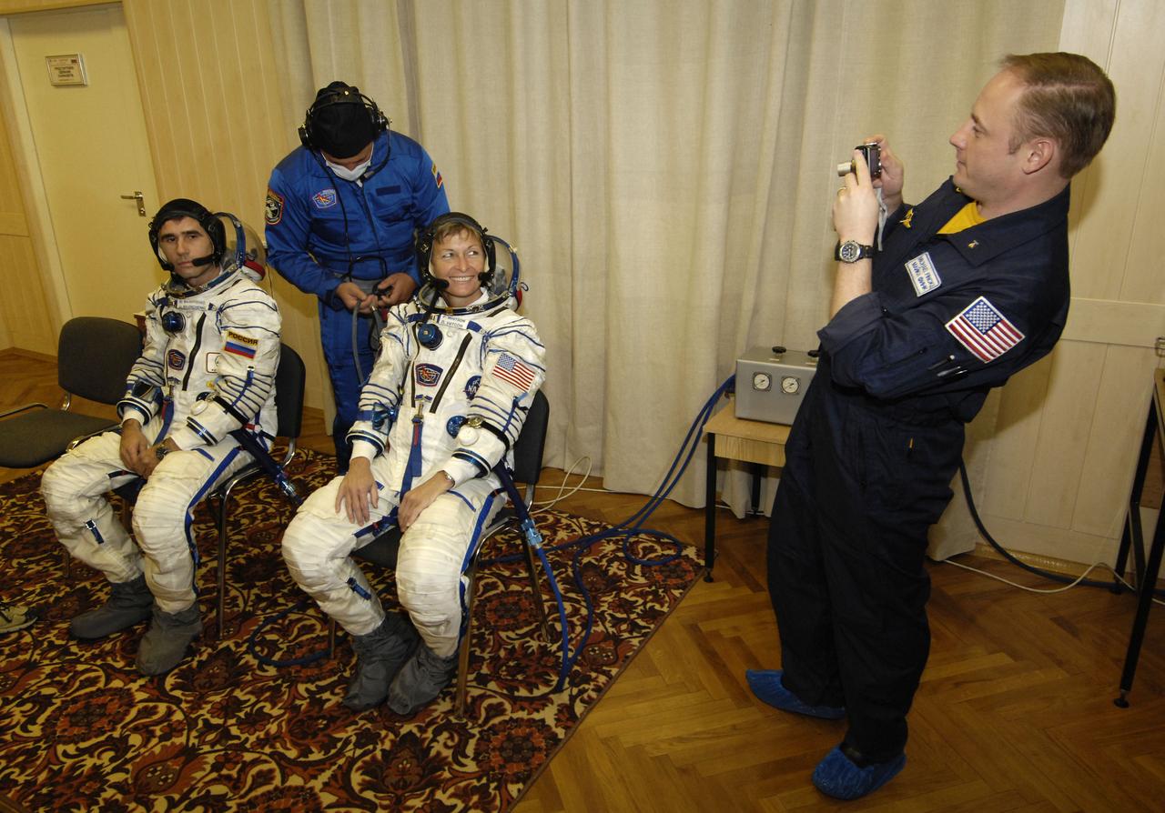 Expedition 16 backup Commander Michael Fincke, right, photographs Expedition 16 Commander Peggy Whitson and Flight Engineer and Soyuz Commander Yuri Malenchenko, left, shortly before they and Malaysian spaceflight participant Sheikh Muszaphar Shukor launched from the Baikonur Cosmodrome in Kazakhstan, Wednesday, Oct. 10, 2007. Their Soyuz TMA-11 spacecraft will dock to the International Space Station on Oct. 12. Whitson and Malenchenko will spend six months on the station, while Shukor will return to Earth Oct. 21 with two of the Expedition 15 crewmembers currently on the complex. Photo Credit: (NASA/Bill Ingalls)