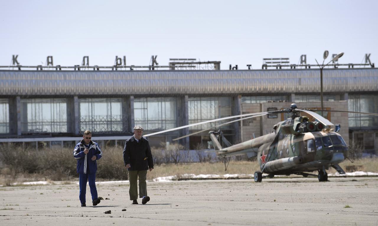 Chief of the NASA Astronaut office, Steve Lindsey, left, and interpreter Paul Kharmats wait at the Arkalyk airport in Kazakhstan as Russian helicopters are refueled, Friday, April 19, 2008. Arkalyk was used as one of the helicopter staging areas for the landing of the Soyuz TMA-11 spacecraft carrying Expedition 16 Commander Peggy Whitson, Flight Engineer and Soyuz Commander Yuri Malenchenko and South Korean spaceflight participant So-yeon Yi. The Soyuz made a ballistic landing, touching down more then 400 kilometers short of the intended target in central Kazakhstan. Photo Credit: (NASA/Bill Ingalls)