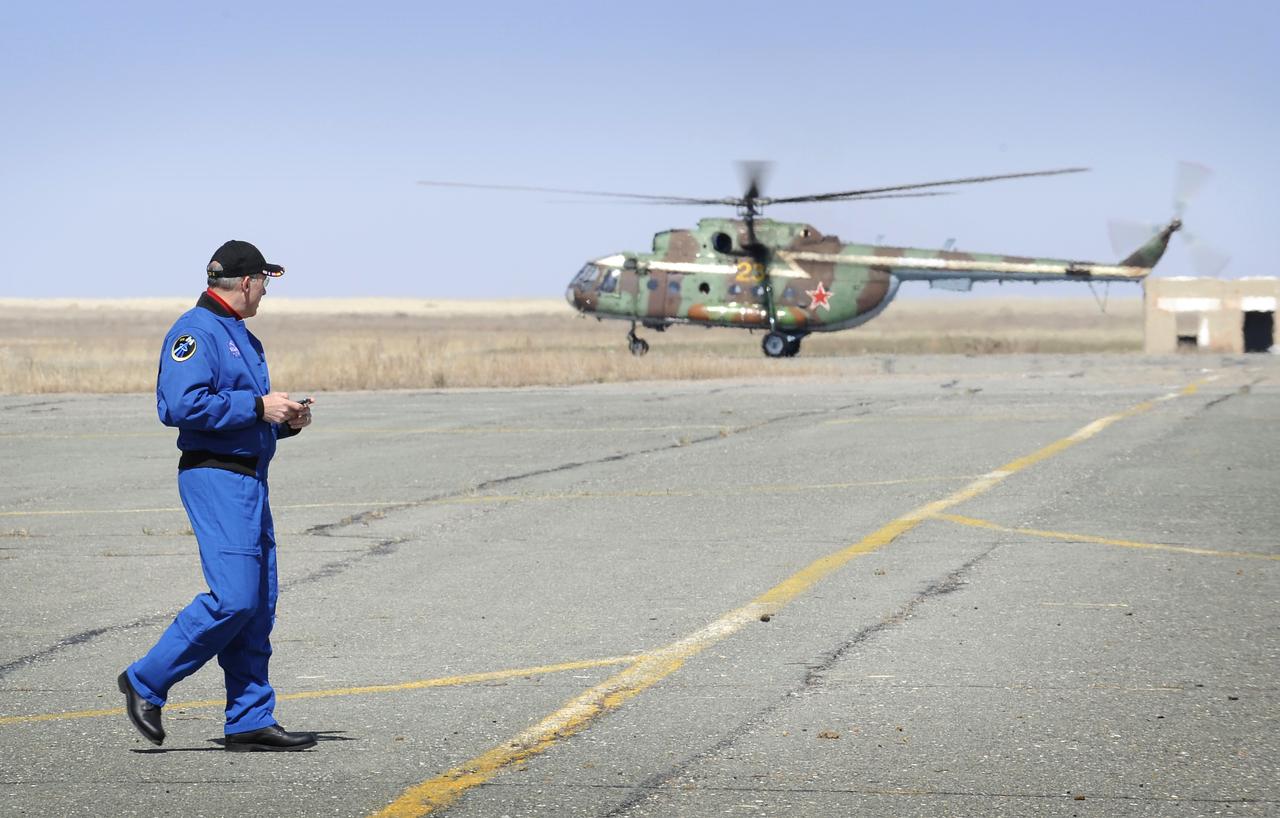 International Space Station Program Manager Michael Suffredini watches as the first wave of helicopters leaves the Arkalyk airport in Kazakhstan in preparation for the Soyuz TMA-11 landing, Friday, April 19, 2008.  The Soyuz TMA-11 spacecraft carrying Expedition 16 Commander Peggy Whitson, Flight Engineer and Soyuz Commander Yuri Malenchenko and South Korean spacelfight participant So-yeon Yi landed in central Kazakhstan to complete 192 days in space for Whitson and Malenchenko and 11 days in orbit for Yi.  Photo Credit: (NASA/Bill Ingalls)