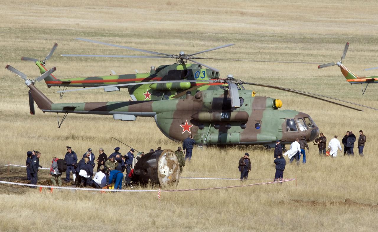 Russian ground crews walk around the Soyuz TMA-11 spacecraft after it landed carrying Expedition 16 Commander Peggy Whitson, Flight Engineer and Soyuz Commander Yuri Malenchenko and South Korean spaceflight participant So-yeon Yi, Friday, April 19, 2008, in central Kazakhstan to complete 192 days in space for Whitson and Malenchenko and 11 days in orbit for Yi. Photo Credit: (NASA/Reuters/Pool)