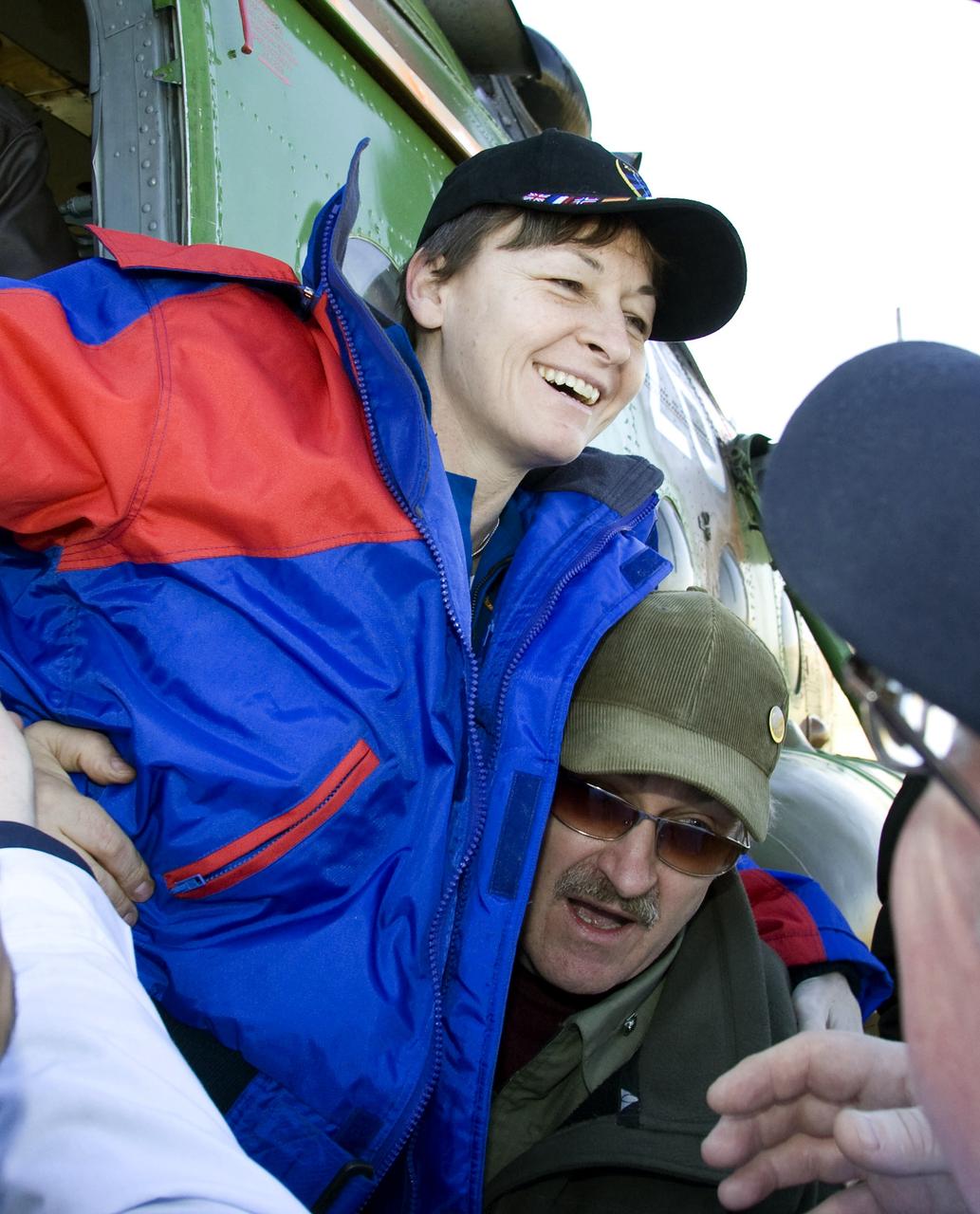Expedition 16 Commander Peggy Whitson is helped out of a helicopter after landing in northern Kazakhstan, Friday, April 19, 2008. Whitson, Flight Engineer and Soyuz Commander Yuri Malenchenko and South Korean spaceflight participant So-yeon Yi landed their Soyuz TMA-11 spacecraft in central Kazakhstan to complete 192 days in space for Whitson and Malenchenko and 11 days in orbit for Yi. Photo Credit: (NASA/Reuters/Pool)