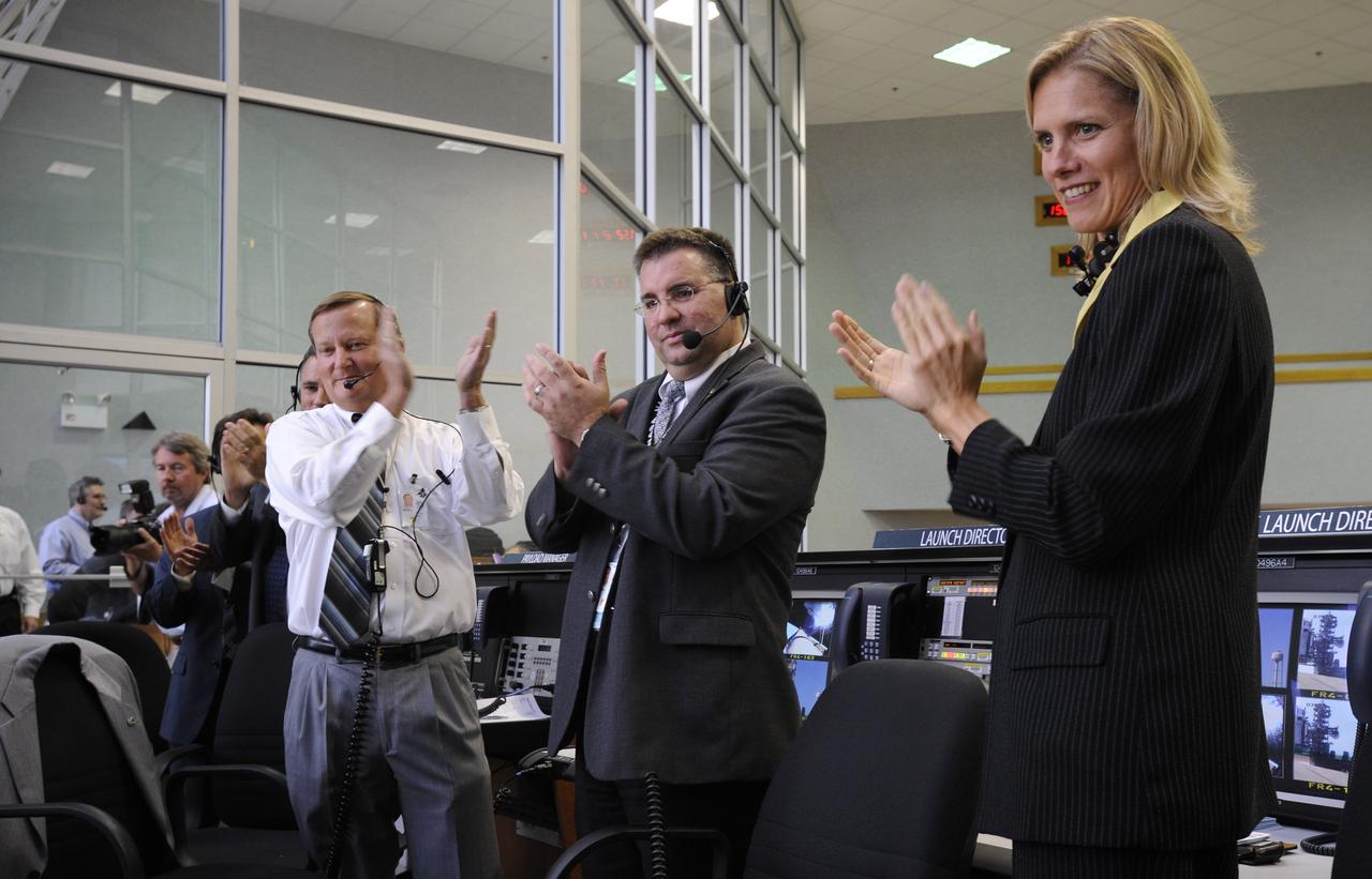 NASA Shuttle Launch Director Michael Leinbach, left, STS-124 Assistant Launch Director Ed Mango, center, and Flow Director for Space Shuttle Discovery Stephanie Stilson clap in the the Launch Control Center after the main engine cut off and successful launch of the Space Shuttle Discovery (STS-124) Saturday, May 31, 2008, at the Kennedy Space Center in Cape Canaveral, Fla. The Shuttle lifted off from launch pad 39A at 5:02 p.m. EDT. Photo Credit: (NASA/Bill Ingalls)