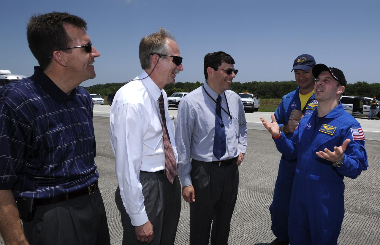 NASA Astronaut Garrett Reisman, right, jokes with NASA Associate Administrator Chris Scolese, 2nd from right, NASA Associate Administrator for Space Operations Bill Gerstenmaier, 3rd from right and NASA Deputy Shuttle Program Manager LeRoy Cain as NASA Astronaut Michael Lopez-Alegria looks on shortly after landing onboard the space shuttle Discovery. Discovery touched down at 11:15 a.m., Saturday, June 14, 2008, at the Kennedy Space Center in Cape Canaveral, Florida. Onboard Discovery with Reisman was the crew of the STS-124 mission, NASA astronauts Mark Kelly, commander; Ken Ham, pilot; Mike Fossum, Ron Garan, Karen Nyberg and Japan Aerospace Exploration Agency astronaut Akihiko Hoshide, all mission specialists. Photo Credit: (NASA/Bill Ingalls)