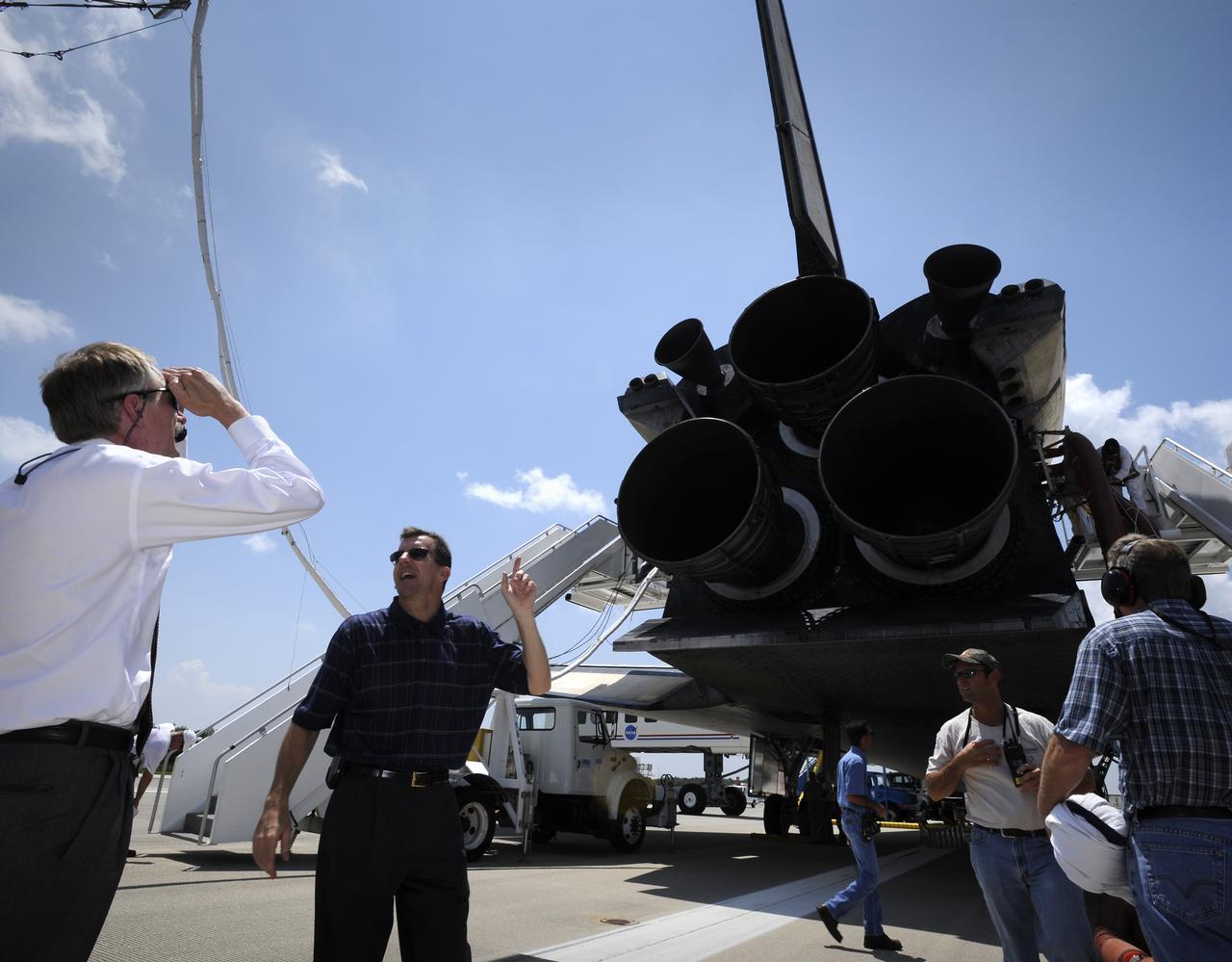 NASA Deputy Shuttle Program Manager LeRoy Cain points out a portion of the space shuttle Discovery to NASA Associate Administrator for Space Operations Bill Gerstenmaier, left, during a walk around shortly after Discovery touched down at 11:15 a.m., Saturday, June 14, 2008, at the Kennedy Space Center in Cape Canaveral, Florida.  During the 14-day STS-124 mission Discovery's crew installed the Japan Aerospace Exploration Agency's large Kibo laboratory and its remote manipulator system leaving a larger space station and one with increased science capabilities. Discovery also brought home NASA astronaut Garrett Reisman after his 3 month mission onboard the International Space Station. Photo Credit: (NASA/Bill Ingalls)