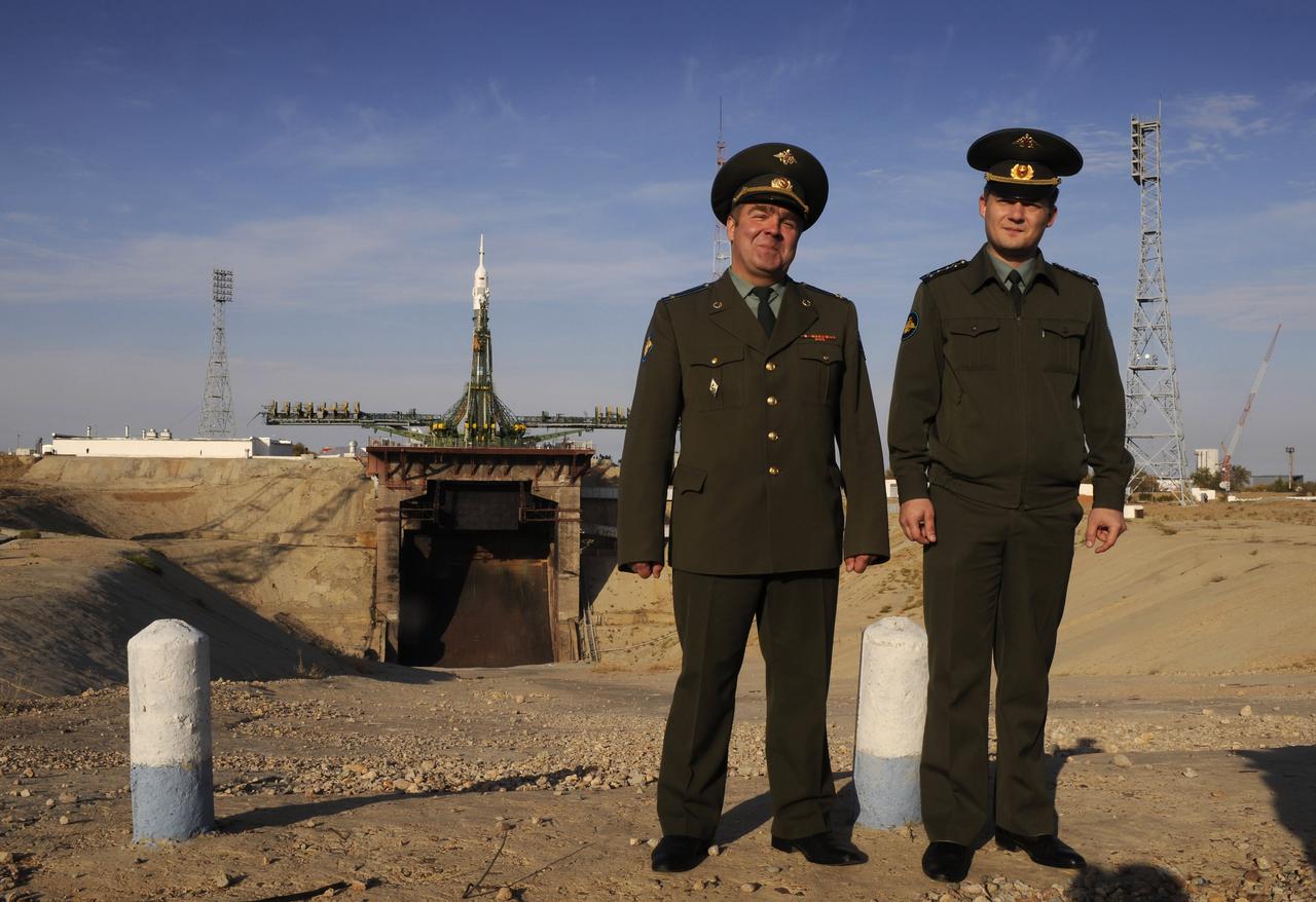 Members of the Russian military pose for a photograph near the flame trench of the Soyuz launch pad at the Baikonur Cosmodrome in Kazakhstan, Friday, Oct. 10, 2008.  The Soyuz TMA-13 spacecraft is scheduled for launch Oct. 12 and will carry Expedition 18 Commander Michael Fincke, Flight Engineer Yuri V. Lonchakov and American spaceflight participant Richard Garriott to the International Space Station.  The three crew members will dock their Soyuz to the International Space Station on Oct. 14. Fincke and Lonchakov will spend six months on the station, while Garriott will return to Earth Oct. 24 with two of the Expedition 17 crew members currently on the International Space Station.  Photo Credit: (NASA/Bill Ingalls)
