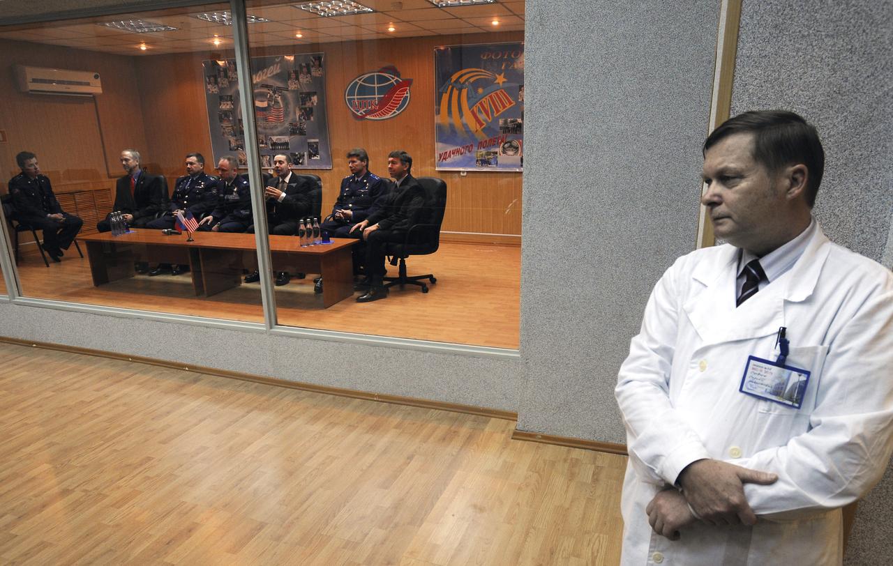 A Russian flight surgeon, right, along with the quarantined prime and backup crews listen to the State Commission give the final approval for the launch of the Soyuz TMA-13 spacecraft, Saturday, Oct. 11, 2008 in Baikonur, Kazakhstan. Expedition 18 Commander Michael Fincke, Flight Engineer Yuri V. Lonchakov and American spaceflight participant Richard Garriott are scheduled to launch Oct. 12 and dock with the International Space Station on Oct. 14. Fincke and Lonchakov will spend six months on the station, while Garriott will return to Earth Oct. 24 with two of the Expedition 17 crew members currently on the International Space Station. Photo Credit: (NASA/Bill Ingalls)