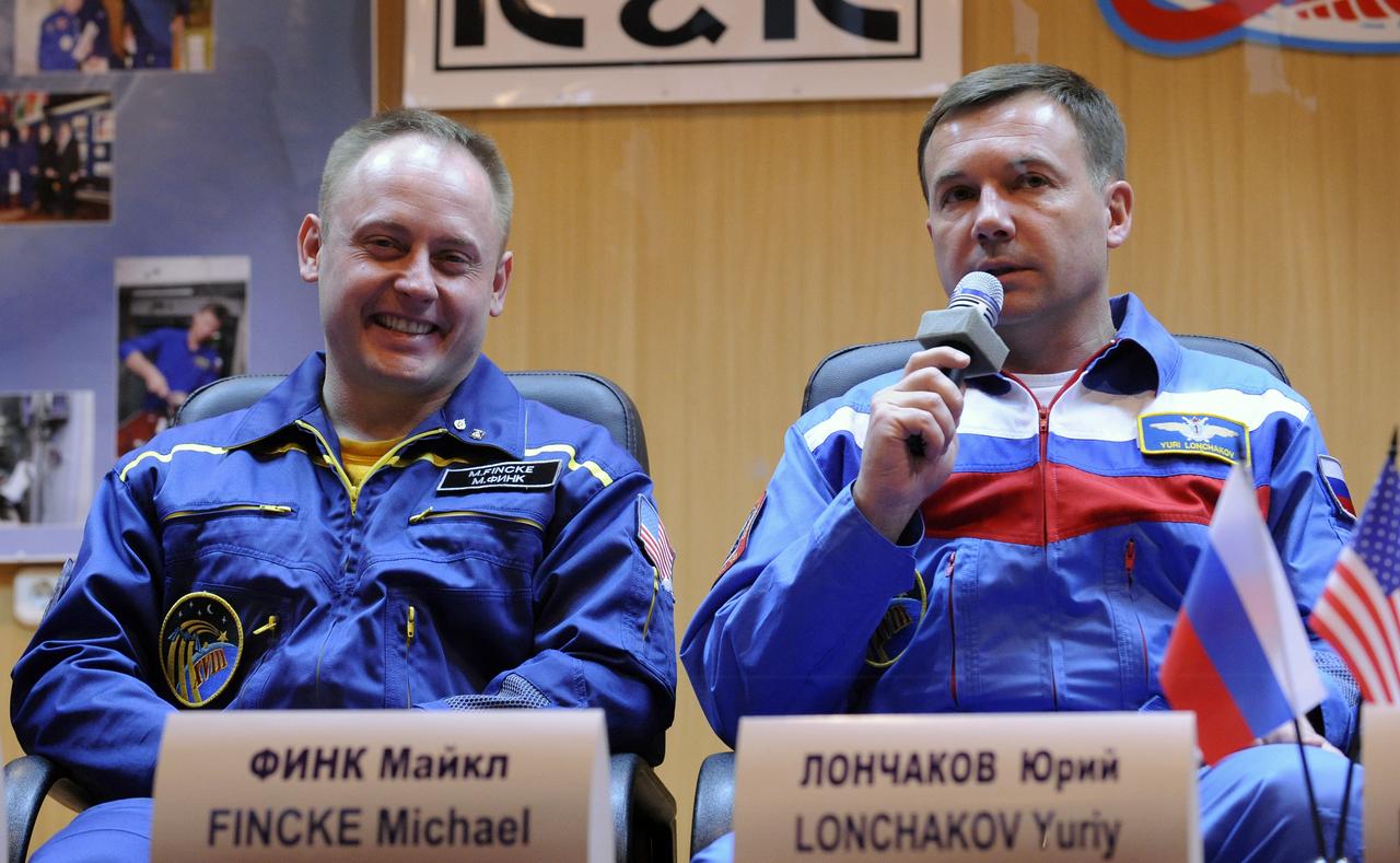 Expedition 18 Commander Michael Fincke, left, and Flight Engineer Yuri V. Lonchakov answer reporters' questions during a press conference held at the Cosmonaut Hotel, Saturday, Oct. 11, 2008, in Baikonur, Kazakhstan. Fincke and Lonchakov will launch on the Soyuz TMA-13 spacecraft along with American spaceflight participant Richard Garriott on Oct. 12 and dock with the International Space Station on Oct. 14. Fincke and Lonchakov will spend six months on the station, while Garriott will return to Earth Oct. 24 with two of the Expedition 17 crew members currently on the International Space Station. Photo Credit: (NASA/Bill Ingalls)