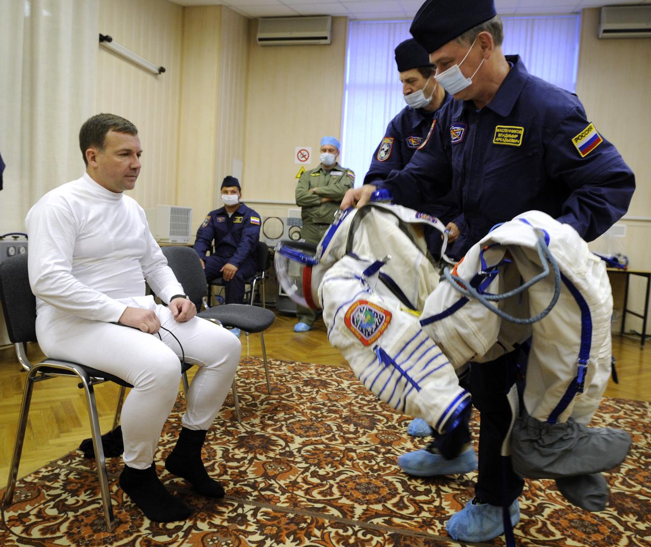 Expedition 18 Flight Engineer Yuri V. Lonchakov dons his Russian Sokol suit hours before he and Expedition 18 Commander Michael Fincke and American spaceflight participant Richard Garriott launch in the Soyuz TMA-13 spacecraft, Sunday, Oct. 12, 2008 from the Baikonur Cosmodrome in Kazakhstan. The three crew members are scheduled to dock with the International Space Station on Oct. 14. Fincke and Lonchakov will spend six months on the station, while Garriott will return to Earth Oct. 24 with two of the Expedition 17 crew members currently on the International Space Station. Photo Credit: (NASA/Bill Ingalls)