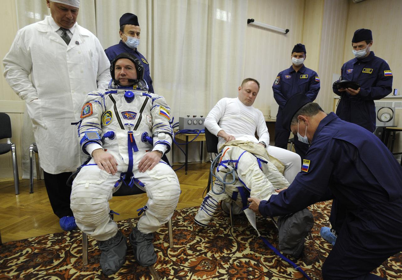Expedition 18 Flight Engineer Yuri V. Lonchakov, left, and Expedition 18 Commander Michael Fincke don their Russian Sokol suits hours before they and American spaceflight participant Richard Garriott launch in the Soyuz TMA-13 spacecraft, Sunday, Oct. 12, 2008 from the Baikonur Cosmodrome in Kazakhstan. The three crew members are scheduled to dock with the International Space Station on Oct. 14. Fincke and Lonchakov will spend six months on the station, while Garriott will return to Earth Oct. 24 with two of the Expedition 17 crew members currently on the International Space Station. Photo Credit: (NASA/Bill Ingalls)