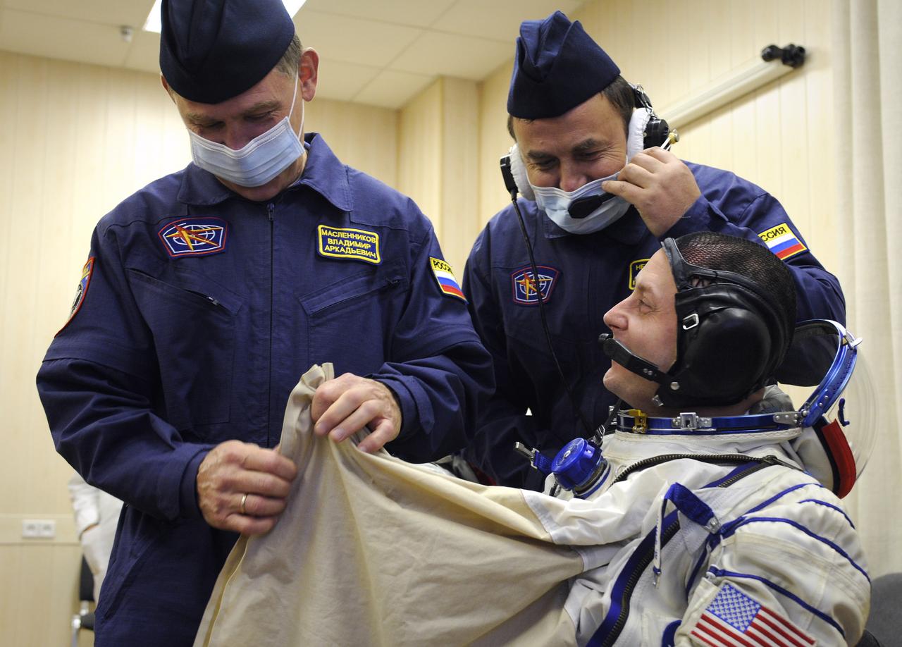 Expedition 18 Commander Michael Fincke dons his Russian Sokol suit hours before he and Expedition 18 Flight Engineer Yuri V. Lonchakov and American spaceflight participant Richard Garriott launch in the Soyuz TMA-13 spacecraft, Sunday, Oct. 12, 2008 from the Baikonur Cosmodrome in Kazakhstan. The three crew members are scheduled to dock with the International Space Station on Oct. 14. Fincke and Lonchakov will spend six months on the station, while Garriott will return to Earth Oct. 24 with two of the Expedition 17 crew members currently on the International Space Station. Photo Credit: (NASA/Bill Ingalls)