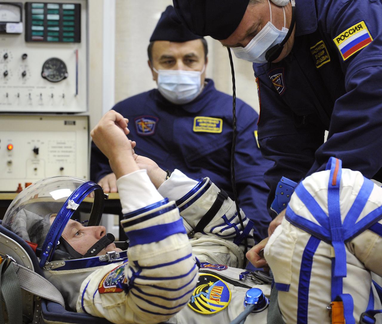 Expedition 18 Commander Michael Fincke has his Russian Sokol suit pressure checked prior to launching in the Soyuz TMA-13 spacecraft with Expedition 18 Flight Engineer Yuri V. Lonchakov and American spaceflight participant Richard Garriott, Sunday, Oct. 12, 2008 from the Baikonur Cosmodrome in Kazakhstan. The three crew members are scheduled to dock with the International Space Station on Oct. 14. Fincke and Lonchakov will spend six months on the station, while Garriott will return to Earth Oct. 24 with two of the Expedition 17 crew members currently on the International Space Station. Photo Credit: (NASA/Bill Ingalls)