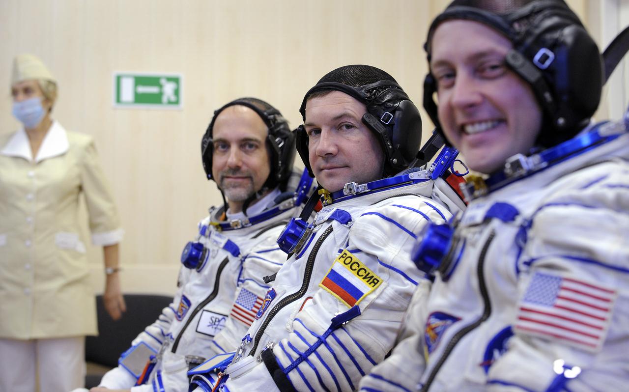 American spaceflight participant Richard Garriott, left, Expedition 18 Flight Engineer Yuri V. Lonchakov and Expedition 18 Commander Michael Fincke, right, smile for the camera after they had their Russian Sokol suits pressure checked in preparation for launch onboard the Soyuz TMA-13 spacecraft, Sunday, Oct. 12, 2008 from the Baikonur Cosmodrome in Kazakhstan. The three crew members are scheduled to dock with the International Space Station on Oct. 14. Fincke and Lonchakov will spend six months on the station, while Garriott will return to Earth Oct. 24 with two of the Expedition 17 crew members currently on the International Space Station. Photo Credit: (NASA/Bill Ingalls)