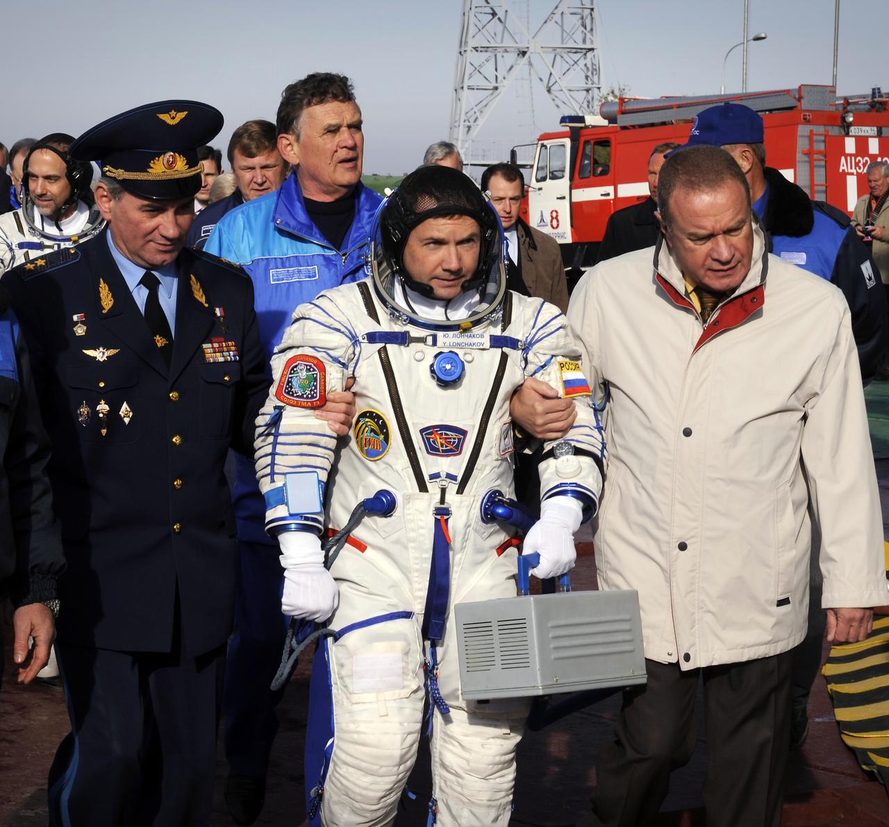 Expedition 18 Flight Engineer Yuri V. Lonchakov walks from the crew bus to the Soyuz rocket with Expedition 18 Commander Michael Fincke, not pictured, and American spaceflight participant Richard Garriott, background left, prior to their launch in the Soyuz TMA-13 spacecraft, Sunday, Oct. 12, 2008 from the Baikonur Cosmodrome in Kazakhstan.  The three crew members are scheduled to dock with the International Space Station on Oct. 14.  Fincke and Lonchakov will spend six months on the station, while Garriott will return to Earth Oct. 24 with two of the Expedition 17 crew members currently on the International Space Station.  Photo Credit: (NASA/Bill Ingalls)