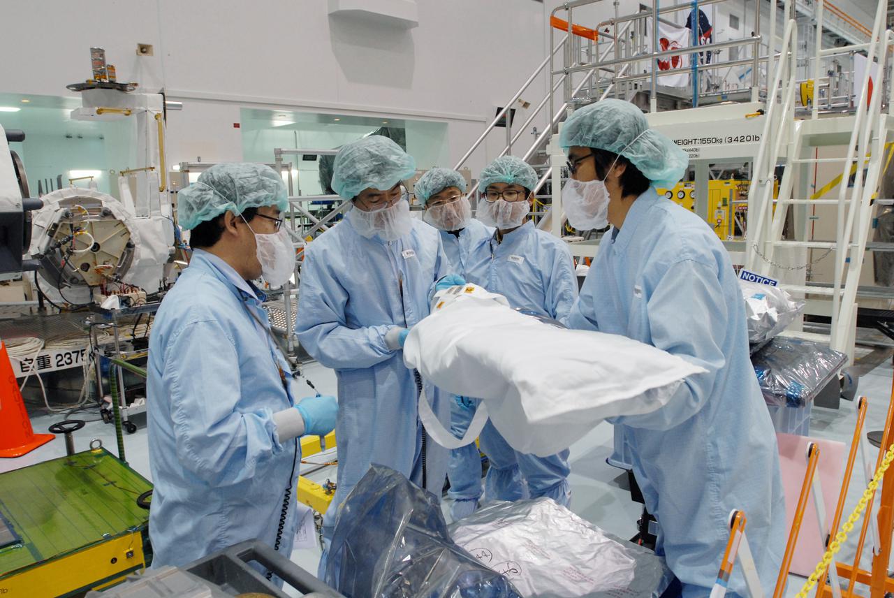 CAPE CANAVERAL, Fla. -- In the Space Station Processing Facility at NASA's Kennedy Space Center in Florida, workers examines equipment for the MAXI (Monitor of All-sky X-ray Image) before it is installed on the Japanese Experiment Module's Experiment Logistics Module-Exposed Section, or ELM-ES. The MAXI is part of space shuttle Endeavour's payload on the STS-127 mission. Using X-ray slit cameras with high sensitivity, the MAXI will continuously monitor astronomical X-ray objects over a broad energy band (0.5 to 30 keV). Endeavour is targeted to launch May 15. Photo credit: NASA_Jim Grossmann