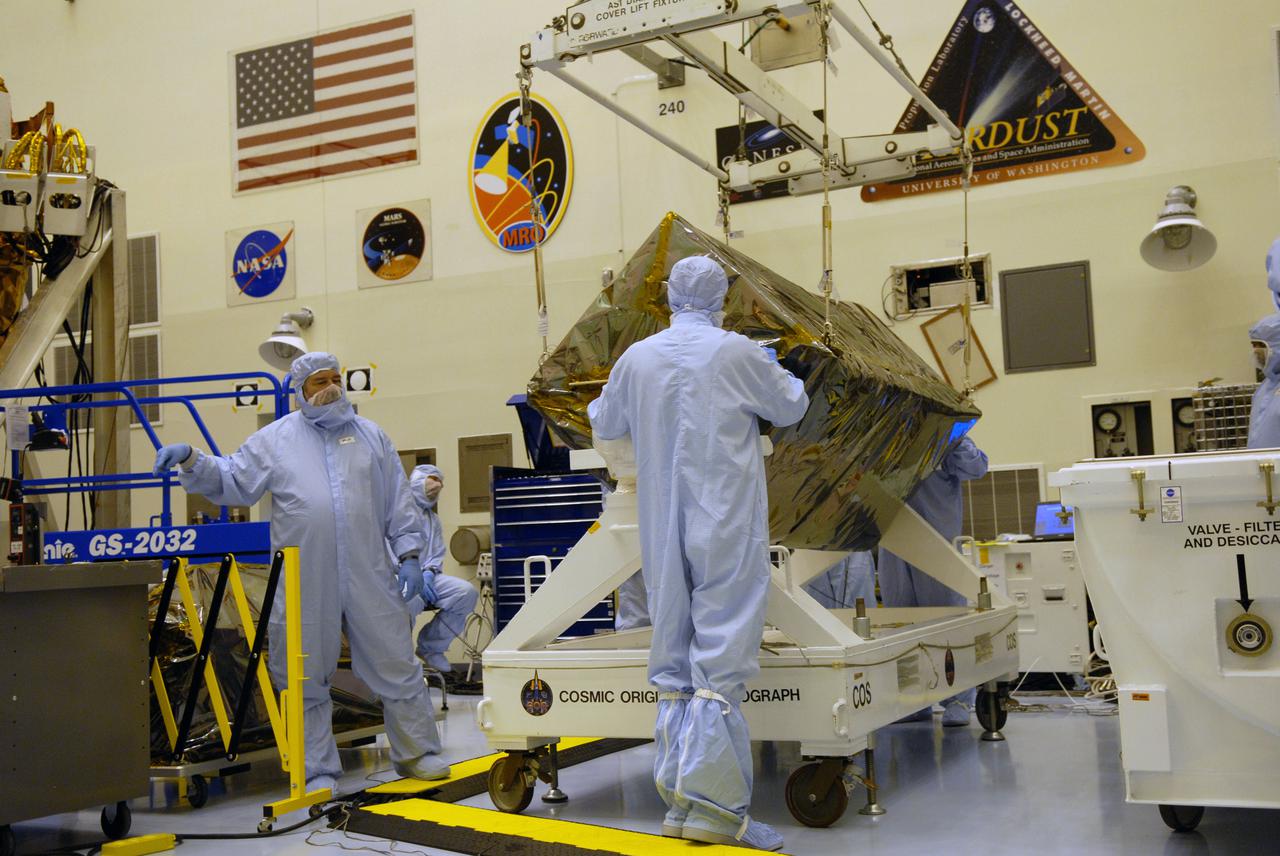 CAPE CANAVERAL, Fla. – In the Payload Hazardous Servicing Facility at NASA's Kennedy Space Center in Florida, under the guidance of the technicians, a crane lowers the Cosmic Origins Spectrograph, or COS, onto a test stand. The COS is part of the payload on space shuttle Atlantis for the Hubble servicing mission, targeted to launch in mid-May. Installing the COS during the mission will effectively restore spectroscopy to Hubble’s scientific arsenal, and at the same time provide the telescope with unique capabilities. COS is designed to study the large-scale structure of the universe and how galaxies, stars and planets formed and evolved. It will help determine how elements needed for life such as carbon and iron first formed and how their abundances have increased over the lifetime of the universe. Photo credit: NASA_Jack Pfaller