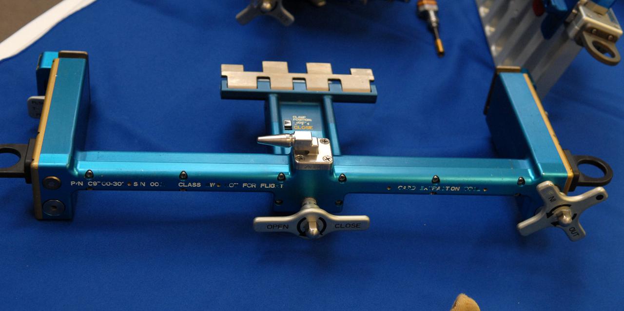 CAPE CANAVERAL, Fla. –  The tools that will be used to service NASA's Hubble Space Telescope on the STS-125 mission are displayed in the NASA News Center at NASA's Kennedy Space Center in Florida.  This is a  closeup of a card extraction and insertion tool to enable removal of electronic cards. On space shuttle Atlantis’ STS-125 mission, Hubble will be serviced for the fifth and final time.  The flight will include five spacewalks during which astronauts will refurbish and upgrade the telescope with these state-of-the-art science instruments. As a result, Hubble's capabilities will be expanded and its operational lifespan extended through at least 2014.  The payload includes a Wide Field Camera 3, fine guidance sensor and the Cosmic Origins Spectrograph. Launch is scheduled for 2:01 p.m. EDT May 11.  Photo credit: NASA_Jack Pfaller