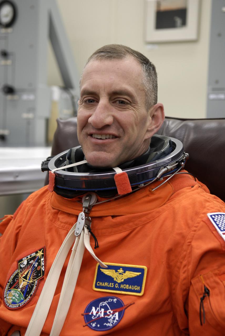 CAPE CANAVERAL, Fla. - In the Operations and Checkout Building at NASA's Kennedy Space Center in Florida, STS-129 Commander Charles O. Hobaugh dons his launch-and-entry suit.  The six astronauts for space shuttle Atlantis’ STS-129 mission are at Kennedy for their launch dress rehearsal, the Terminal Countdown Demonstration Test, on Launch Pad 39A.  Additional training associated with the test was done last month, but the simulated countdown was postponed because of a scheduling conflict with the launch of NASA’s Ares I-X test rocket.  Launch of Atlantis on its STS-129 mission to the International Space Station is set for Nov. 16.  On STS-129, the crew will deliver to the station two spare gyroscopes, two nitrogen tank assemblies, two pump modules, an ammonia tank assembly and a spare latching end effector for the station's robotic arm.  For information on the STS-129 crew and mission objectives, visit http:__www.nasa.gov_mission_pages_shuttle_shuttlemissions_sts129_index.html. Photo credit: NASA_Kim Shiflett