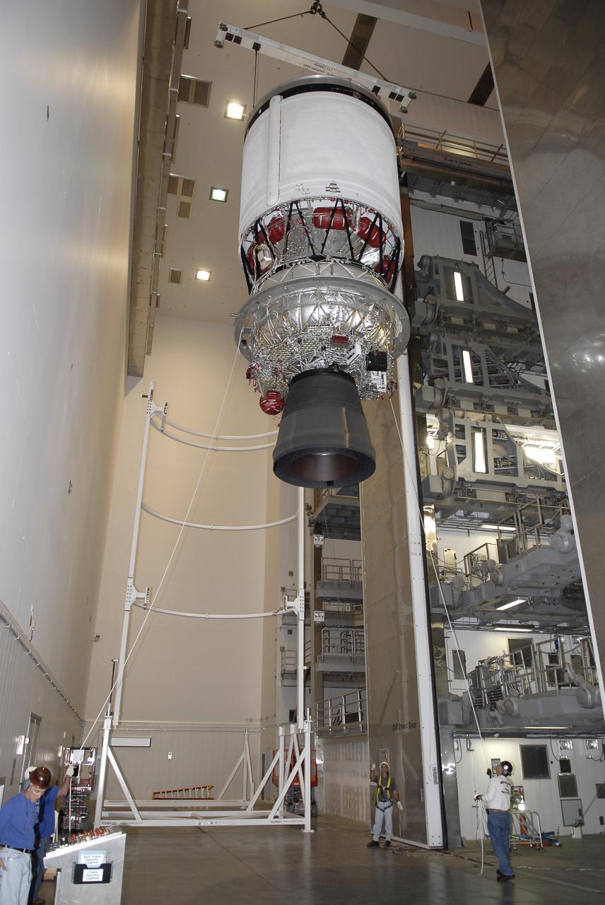 CAPE CANAVERAL, Fla. – Workers lower the second stage of a Delta IV rocket from a test cell in the hangar of the Delta Operations Center at Cape Canaveral Air Force Station in Florida toward a turnover stand following the completion of nozzle extension deployment system testing. The United Launch Alliance Delta IV rocket is slated to launch GOES-P, the latest Geostationary Operational Environmental Satellite developed by NASA for the National Oceanic and Atmospheric Administration, or NOAA. Next, the second stage will be transported to the Horizontal Integration Facility where it will be inspected and prepared for mating with the Delta IV rocket's first stage. GOES-P, a meteorological satellite, is designed to watch for storm development and observed current weather conditions on Earth. Launch of GOES-P is scheduled for no earlier than Feb. 25, 2010, from Launch Complex 37. For information on GOES-P, visit http:__goespoes.gsfc.nasa.gov_goes_spacecraft_n_p_spacecraft.html. Photo credit: NASA_Glenn Benson