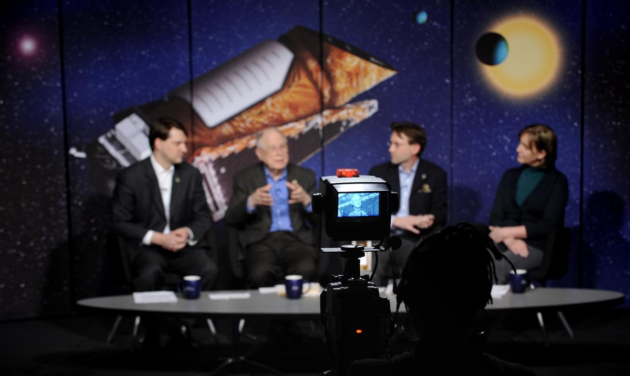William Borucki, principal investigator for Kepler Science at Ames Research Center, Moffett Field, Calif., second from left, is seen through a television camer monitor as he talks about the Kepler mission during a media briefing, Thursday, Feb. 19, 2008, at NASA Headquarters in Washington. Kepler, the first mission with the ability to find planets like earth, is scheduled to launch on March 5, 2009 from Cape Canaveral Air Force Station, Fla. aboard a Delta II rocket.  Photo Credit: (NASA/Paul. E. Alers)