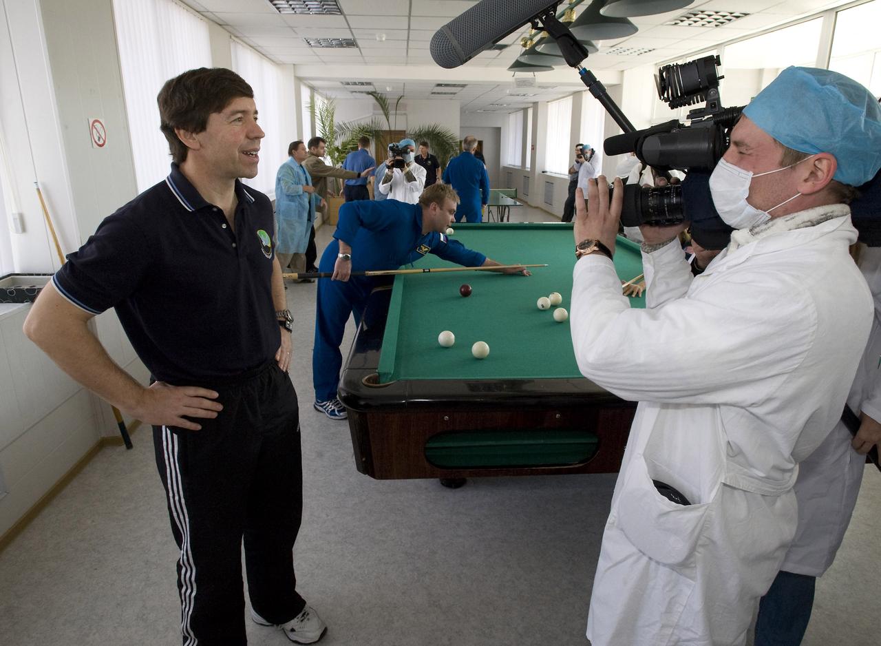 Expedition 19 Flight Engineer Michael R. Barratt is interviewed by members of the press during a recreation break at the Cosmonaut Hotel, Saturday, March 21, 2009 in Baikonur, Kazakhstan.  (Photo Credit: NASA/Bill Ingalls)