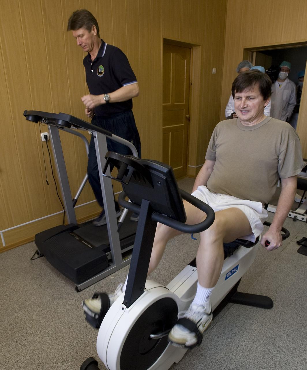 Expedition 19 Commander Gennady I. Padalka, left, and Spaceflight Participant Charles Simonyi exercise at the Cosmonaut Hotel, Saturday, March 21, 2009 in Baikonur, Kazakhstan. (Photo Credit: NASA/Bill Ingalls)