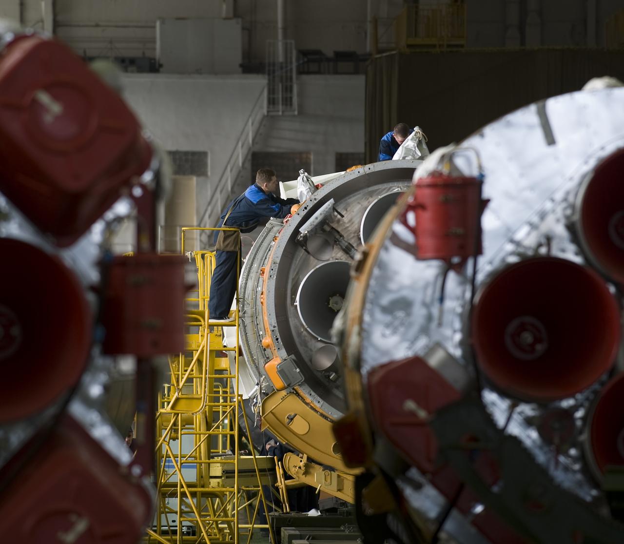 Russian engineers prepare the Soyuz TMA-14 spacecraft and boosters for mating Monday, March 23, 2009 at the Baikonur Cosmodrome in Kazakhstan. The Soyuz is scheduled to launch the crew of Expedition 19 and a spaceflight participant on March 26, 2009. Photo Credit: (NASA/Bill Ingalls)