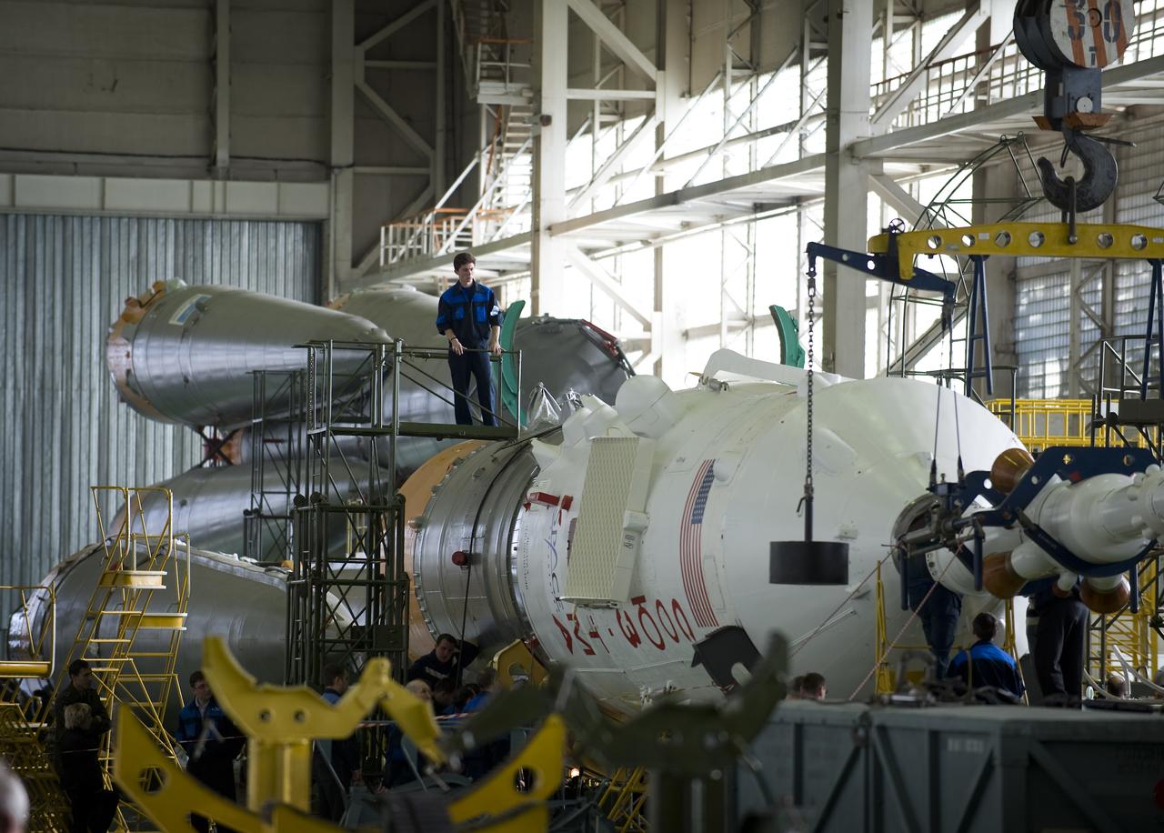 Russian engineers prepare the Soyuz TMA-14 spacecraft and boosters for mating Monday, March 23, 2009 at the Baikonur Cosmodrome in Kazakhstan. The Soyuz is scheduled to launch the crew of Expedition 19 and a spaceflight participant on March 26, 2009. Photo Credit: (NASA/Bill Ingalls)