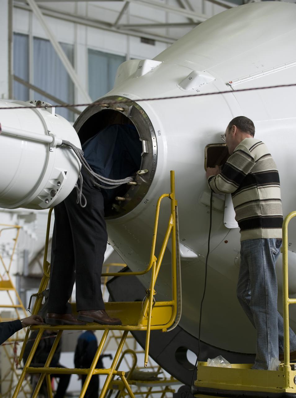 Russian engineers prepare the Soyuz TMA-14 spacecraft and boosters for mating Monday, March 23, 2009 at the Baikonur Cosmodrome in Kazakhstan. The Soyuz is scheduled to launch the crew of Expedition 19 and a spaceflight participant on March 26, 2009. Photo Credit: (NASA/Bill Ingalls)