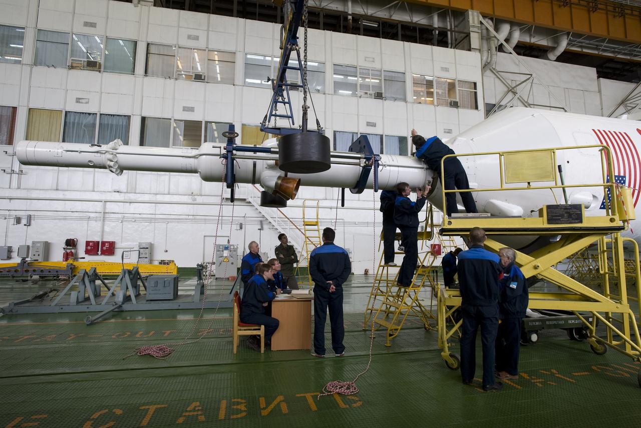 The Soyuz escape tower is being attached to the Soyuz TMA-14 spacecraft and boosters Monday, March 23, 2009 at the Baikonur Cosmodrome in Kazakhstan. The Soyuz is scheduled to launch the crew of Expedition 19 and a spaceflight participant on March 26, 2009. Photo Credit: (NASA/Bill Ingalls)