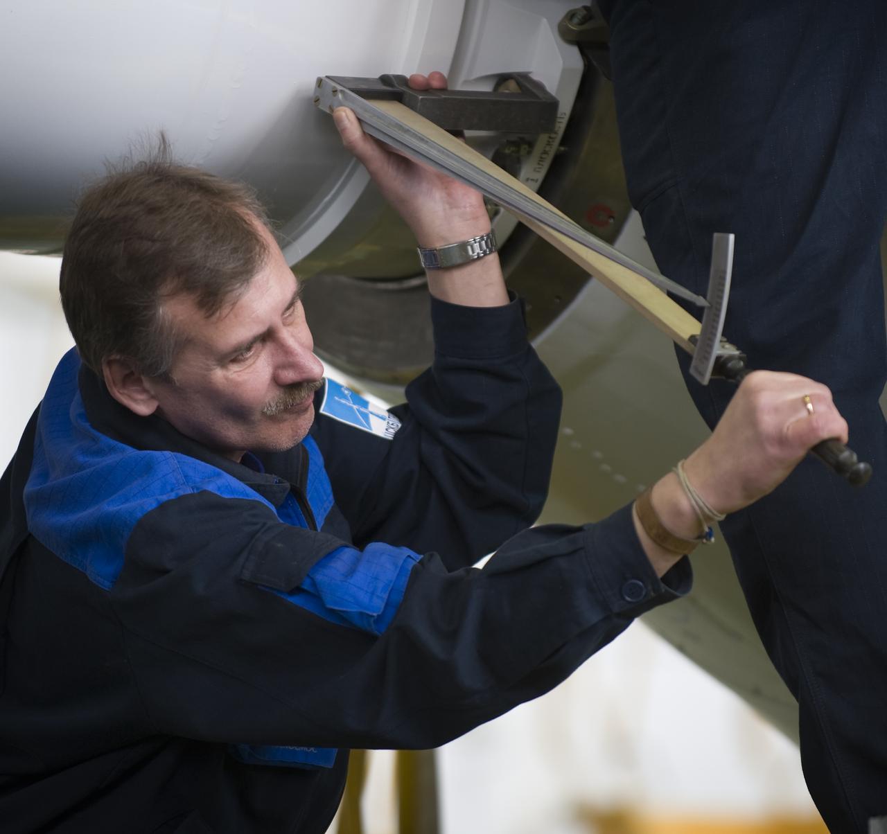 Russian engineers attach the escape tower to the Soyuz TMA-14 spacecraft and boosters Monday, March 23, 2009 at the Baikonur Cosmodrome in Kazakhstan. The Soyuz is scheduled to launch the crew of Expedition 19 and a spaceflight participant on March 26, 2009. Photo Credit: (NASA/Bill Ingalls)