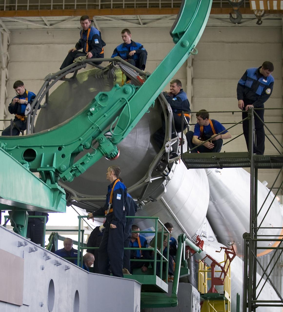 Engineers wait on the Soyuz second stage for the arrival of the Soyuz TMA-14 spacecraft and third stage for final assembly Monday, March 23, 2009 at the Baikonur Cosmodrome in Kazakhstan. The Soyuz is scheduled to launch the crew of Expedition 19 and a spaceflight participant on March 26, 2009. Photo Credit: (NASA/Bill Ingalls)