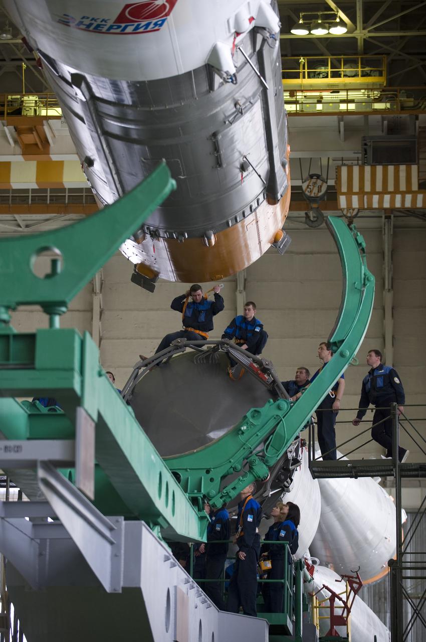 Engineers assemble the Soyuz TMA-14 spacecraft, escape tower and all three stages Monday, March 23, 2009 at the Baikonur Cosmodrome in Kazakhstan. The Soyuz is scheduled to launch the crew of Expedition 19 and a spaceflight participant on March 26, 2009. Photo Credit: (NASA/Bill Ingalls)