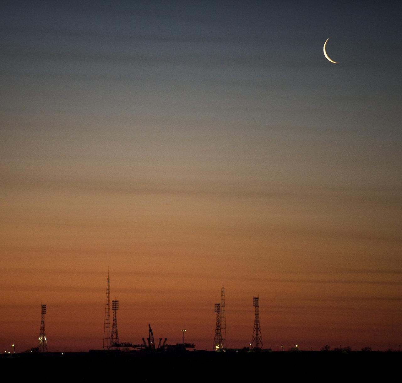 The moon rises in the early morning hours shortly before the Soyuz rocket is rolled out to the launch pad Tuesday, March 24, 2009 at the Baikonur Cosmodrome in Kazakhstan. The Soyuz is scheduled to launch the crew of Expedition 19 and a spaceflight participant on March 26, 2009. Photo Credit: (NASA/Bill Ingalls)