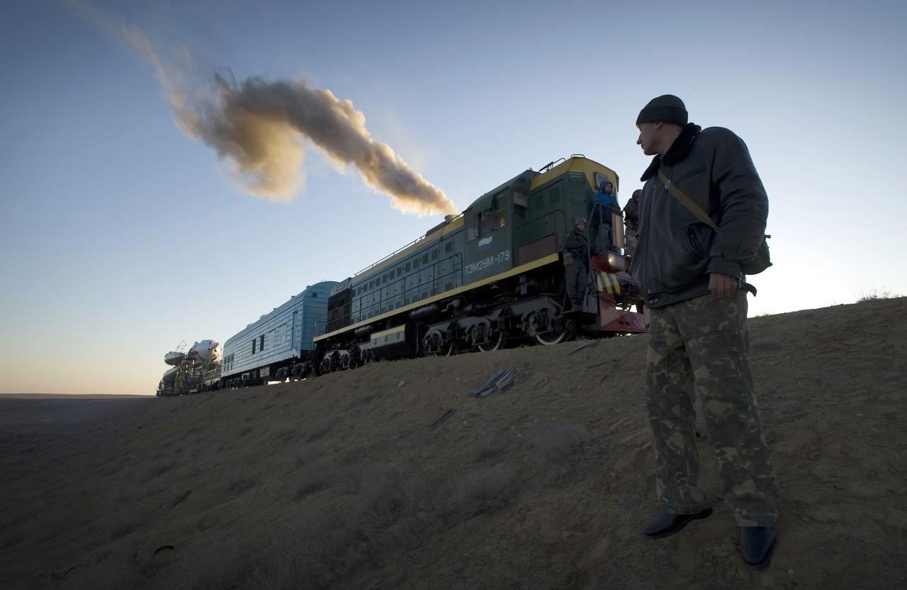 A Russian security member monitors the railroad tracks as the Soyuz rocket rolls out to the launch pad Tuesday, March 24, 2009 at the Baikonur Cosmodrome in Kazakhstan. The Soyuz is scheduled to launch the crew of Expedition 19 and a spaceflight participant on March 26, 2009. Photo Credit: (NASA/Bill Ingalls)