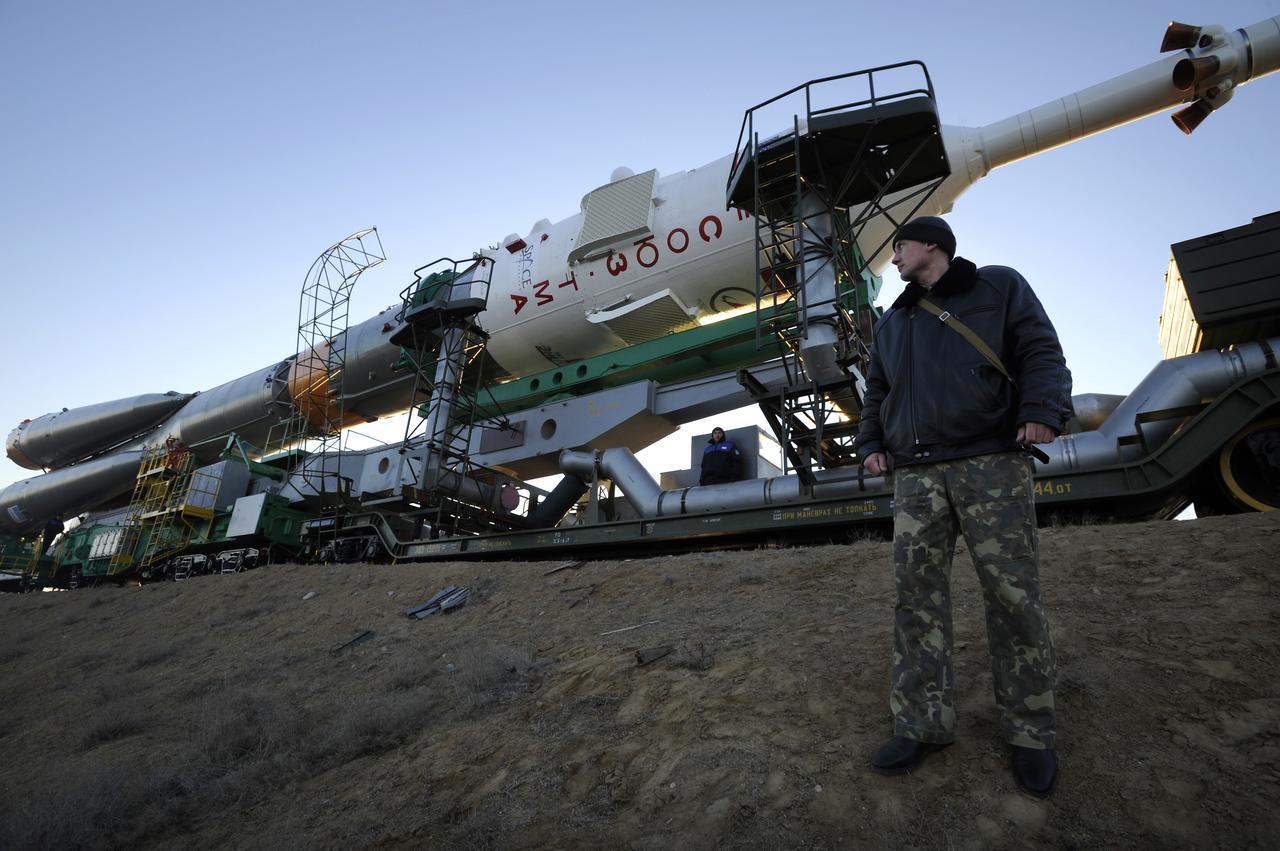 A Russian security member monitors the railroad tracks as the Soyuz rocket rolls out to the launch pad Tuesday, March 24, 2009 at the Baikonur Cosmodrome in Kazakhstan. The Soyuz is scheduled to launch the crew of Expedition 19 and a spaceflight participant on March 26, 2009. Photo Credit: (NASA/Bill Ingalls)