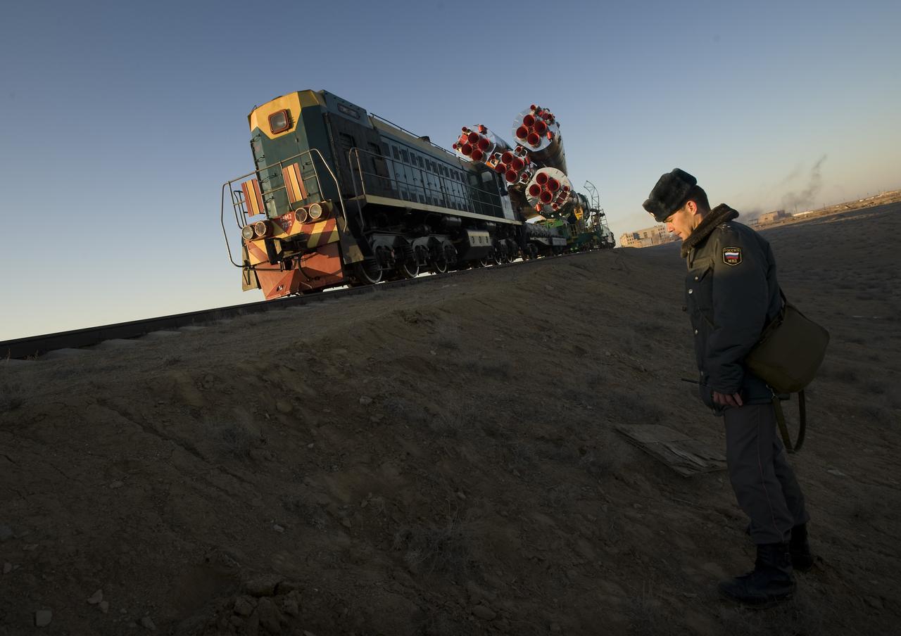 A Russian security member monitors the railroad tracks as the Soyuz rocket rolls out to the launch pad Tuesday, March 24, 2009 at the Baikonur Cosmodrome in Kazakhstan. The Soyuz is scheduled to launch the crew of Expedition 19 and a spaceflight participant on March 26, 2009. Photo Credit: (NASA/Bill Ingalls)