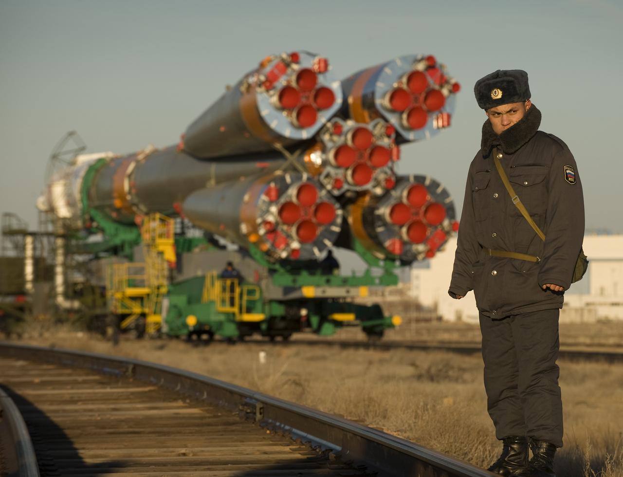 A Russian security member monitors the railroad tracks as the Soyuz rocket rolls out to the launch pad Tuesday, March 24, 2009 at the Baikonur Cosmodrome in Kazakhstan. The Soyuz is scheduled to launch the crew of Expedition 19 and a spaceflight participant on March 26, 2009. Photo Credit: (NASA/Bill Ingalls)