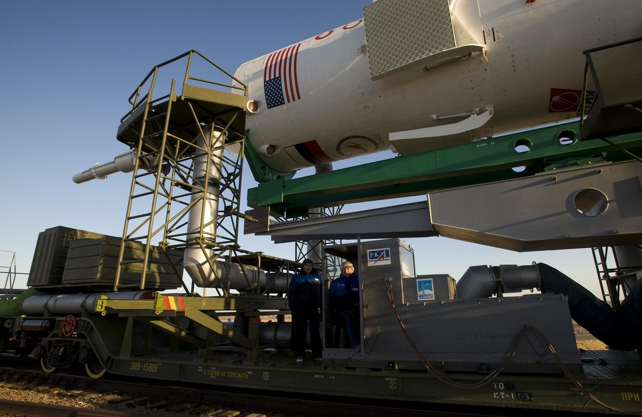 Russian engineers monitor the Soyuz rocket as it rolls out to the launch pad Tuesday, March 24, 2009 at the Baikonur Cosmodrome in Kazakhstan. The Soyuz is scheduled to launch the crew of Expedition 19 and a spaceflight participant on March 26, 2009. Photo Credit: (NASA/Bill Ingalls)