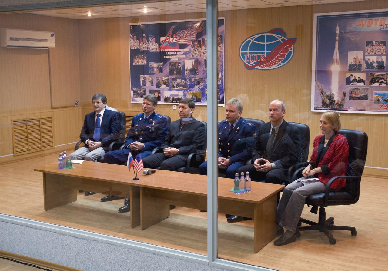 Spaceflight Participant Charles Simonyi, left, Expedition 19 Commander Gennady I. Padalka, Flight Engineer Michael R. Barratt, third from left, backup Expedition 19 flight engineer Maxim Suraev, backup commander Jeffrey Williams and backup spaceflight participant Esther Dyson, far right, are seen in quarantine behind glass during the State Commission meeting on Wednesday, March 25, 2009 in Baikonur, Kazakhstan. Photo Credit: (NASA/Bill Ingalls)