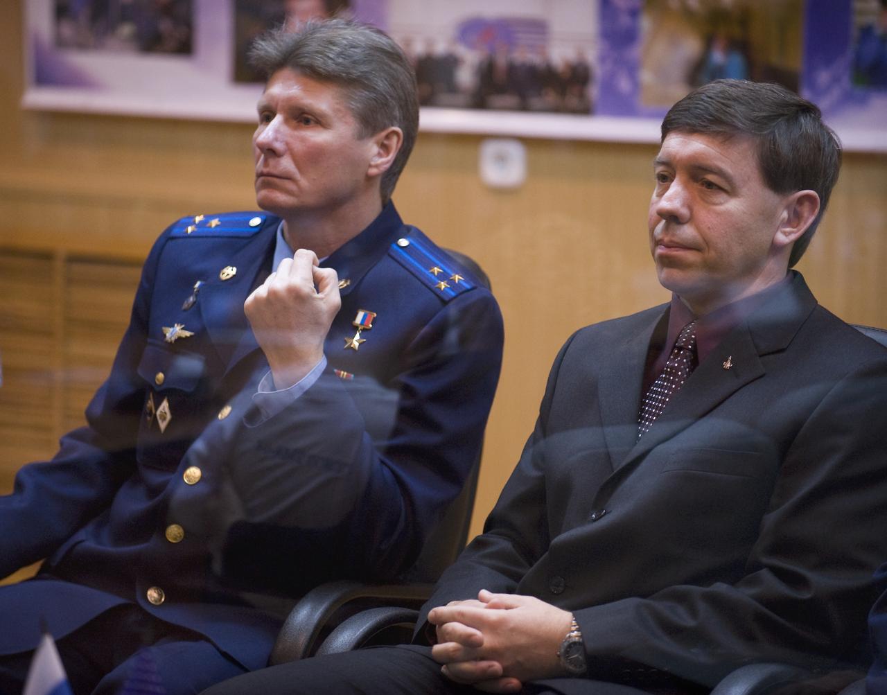 Expedition 19 Commander Gennady I. Padalka, left, and Flight Engineer Michael R. Barratt are seen in quarantine behind glass during the State Commission meeting on Wednesday, March 25, 2009 in Baikonur, Kazakhstan.  Photo Credit: (NASA/Bill Ingalls)