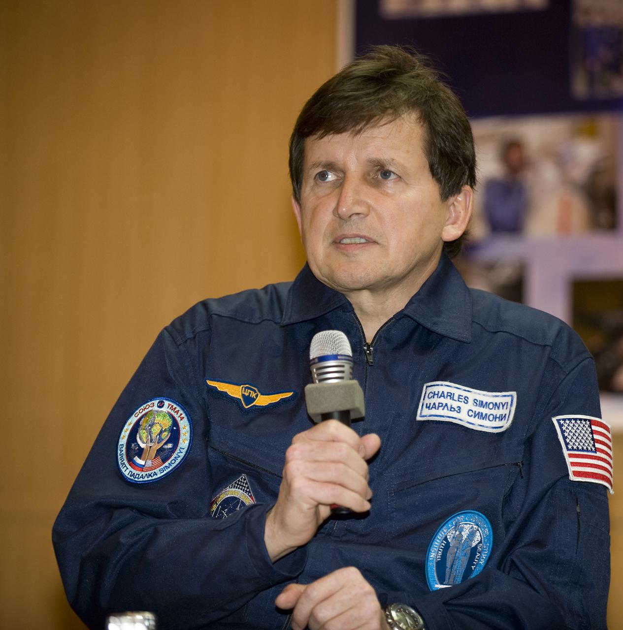 Spaceflight Participant Charles Simonyi answers questions from behind glass during a press conference on Wednesday, March 25, 2009 at the Cosmonaut Hotel in Baikonur, Kazakhstan.  Photo Credit: (NASA/Bill Ingalls)