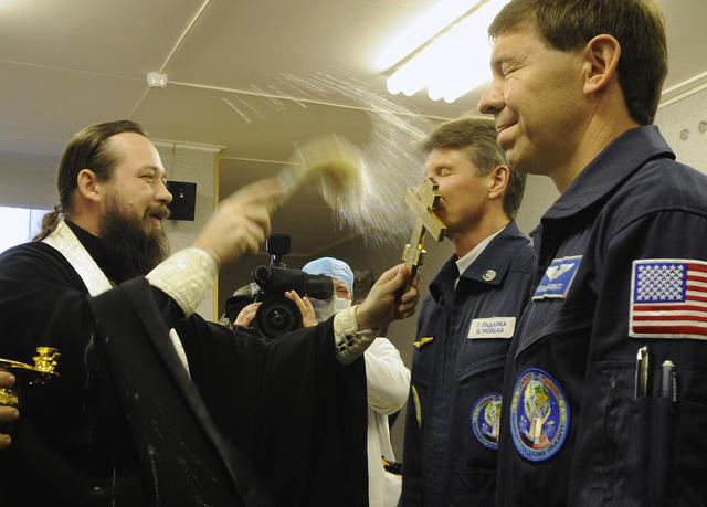 Expedition 19 Commander Gennady I. Padalka receives the traditional blessing at the Cosmonaut Hotel on the morning of his Soyuz launch with Expedition 19 Flight Engineer Michael R. Barratt and Spaceflight Participant Charles Simonyi to the International Space Station on Thursday, March 26, 2009 in Baikonur, Kazakhstan. (Photo Credit: NASA/Bill Ingalls)