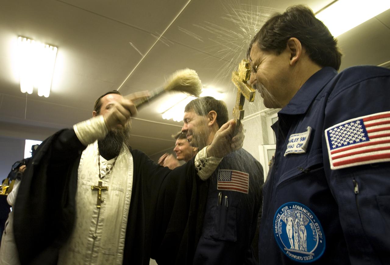Spaceflight Participant Charles Simonyi receives the traditional blessing at the Cosmonaut Hotel on the morning of his Soyuz launch with Expedition 19 Expedition 19 Commander Gennady I. Padalka and Flight Engineer Michael R. Barratt to the International Space Station on Thursday, March 26, 2009 in Baikonur, Kazakhstan. (Photo Credit: NASA/Bill Ingalls)