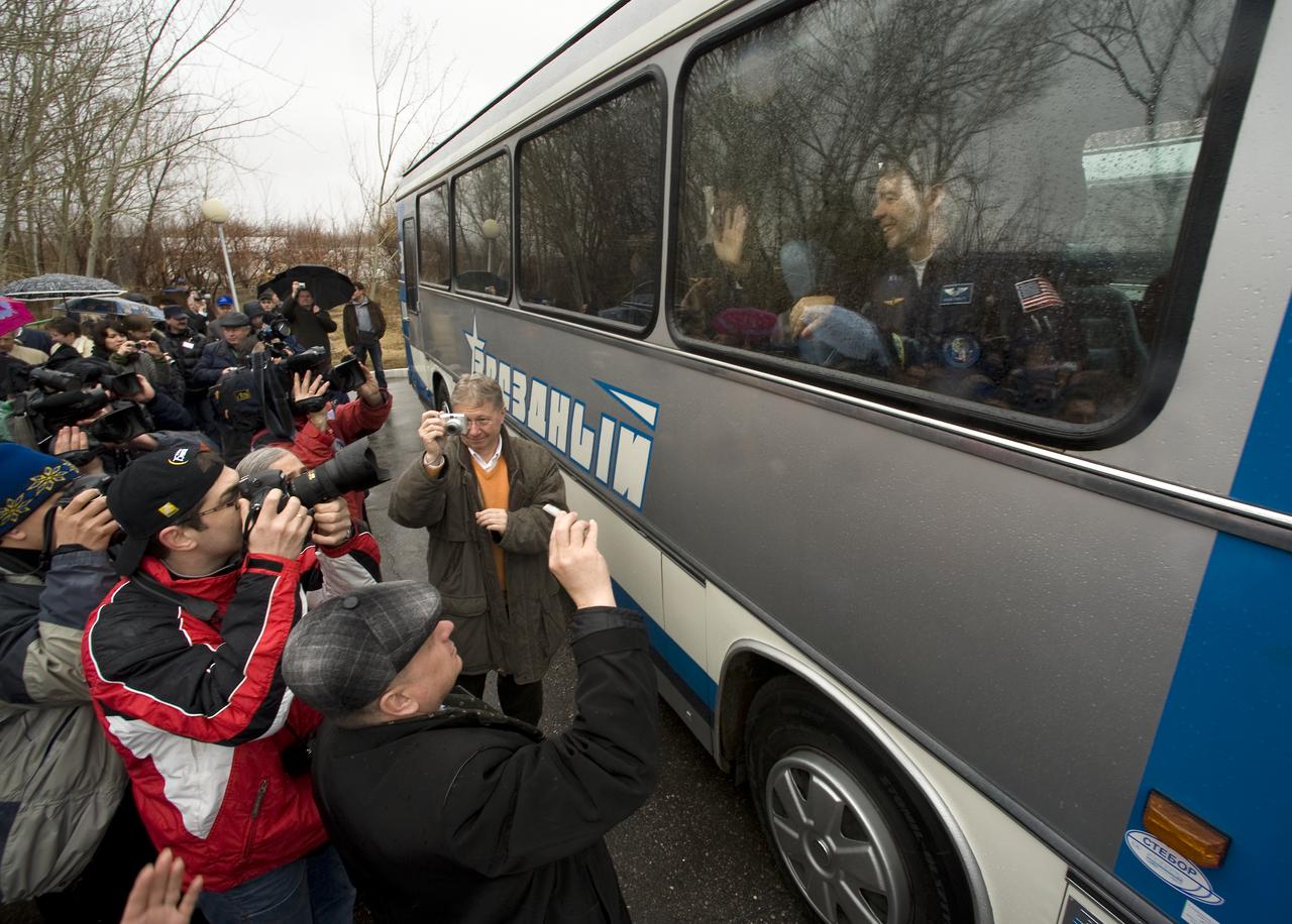 Expedition 19 Flight Engineer Michael R. Barratt is seen on the bus outside the Cosmonaut Hotel as he, Commander Gennady I. Padalka and Spaceflight Participant Charles Simonyi depart the hotel for building 254 where they will don their flights suits in preparation for their Soyuz launch to the International Space Station on Thursday, March 26, 2009 in Baikonur, Kazakhstan. (Photo Credit: NASA/Bill Ingalls)