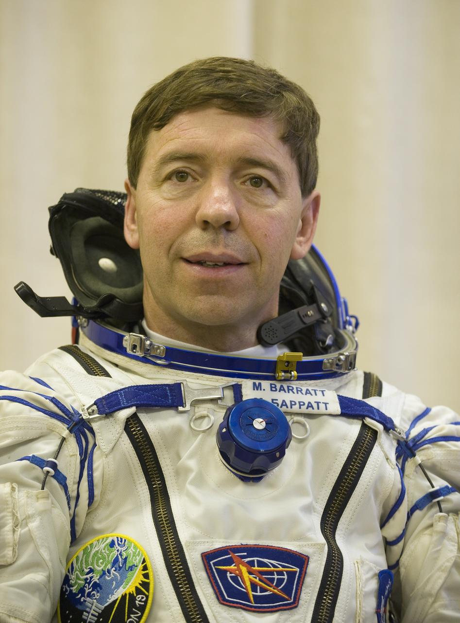 Expedition 19 Flight Engineer Michael R. Barratt waits to have his Russian Sokol suit pressure checked in preparation for his Soyuz launch to the International Space Station with Expedition 19 Commander Gennady I. Padalka and Spaceflight Participant Charles Simonyi on Thursday, March 26, 2009 in Baikonur, Kazakhstan. (Photo Credit: NASA/Bill Ingalls)