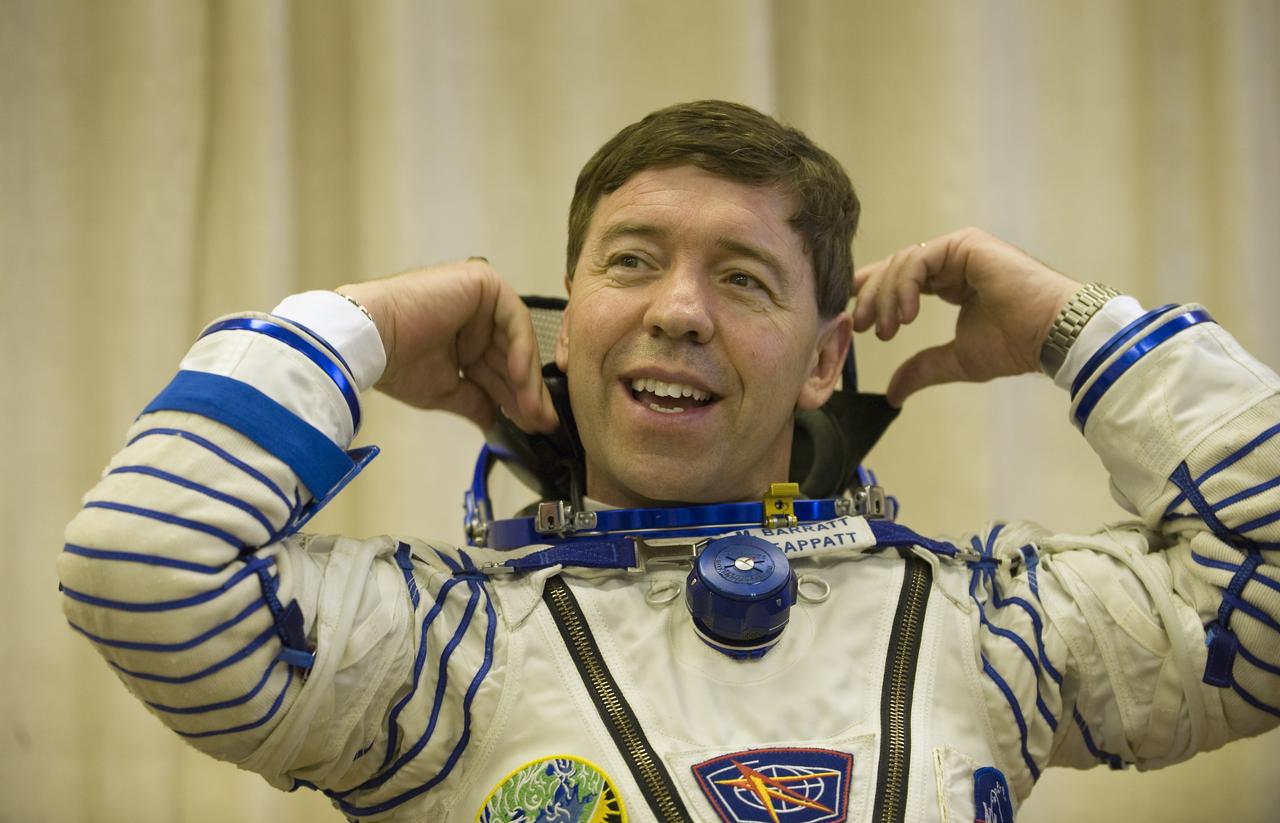 Expedition 19 Flight Engineer Michael R. Barratt waits to have his Russian Sokol suit pressure checked in preparation for his Soyuz launch to the International Space Station with Expedition 19 Commander Gennady I. Padalka and Spaceflight Participant Charles Simonyi on Thursday, March 26, 2009 in Baikonur, Kazakhstan. (Photo Credit: NASA/Bill Ingalls)
