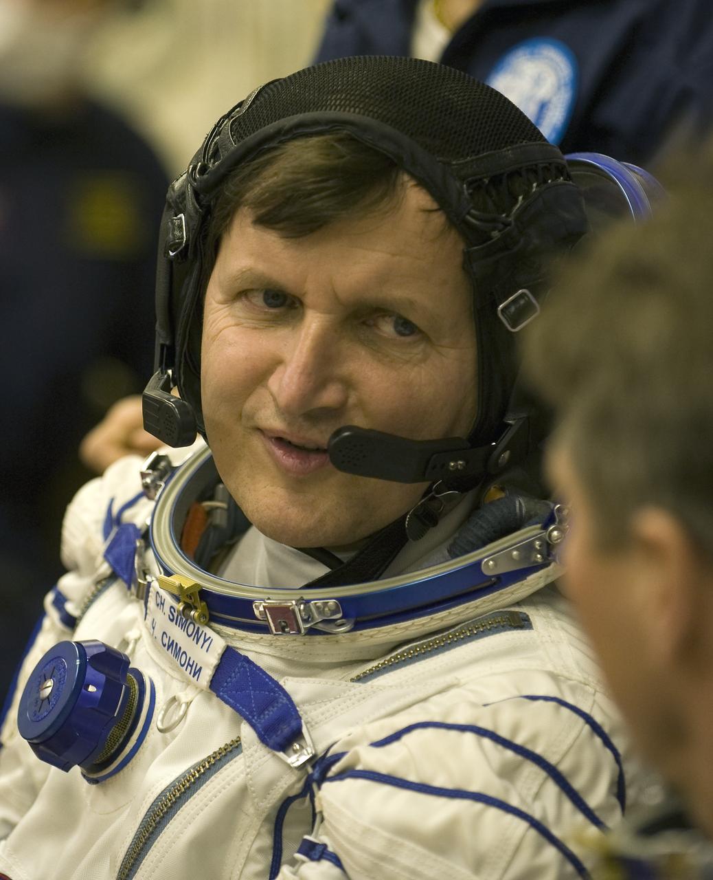 Spaceflight Participant Charles Simonyi talks with Expedition 19 Commander Gennady I. Padalka as he waits to have his Russian Sokol suit pressure checked on Thursday, March 26, 2009 in Baikonur, Kazakhstan. (Photo Credit: NASA/Bill Ingalls)