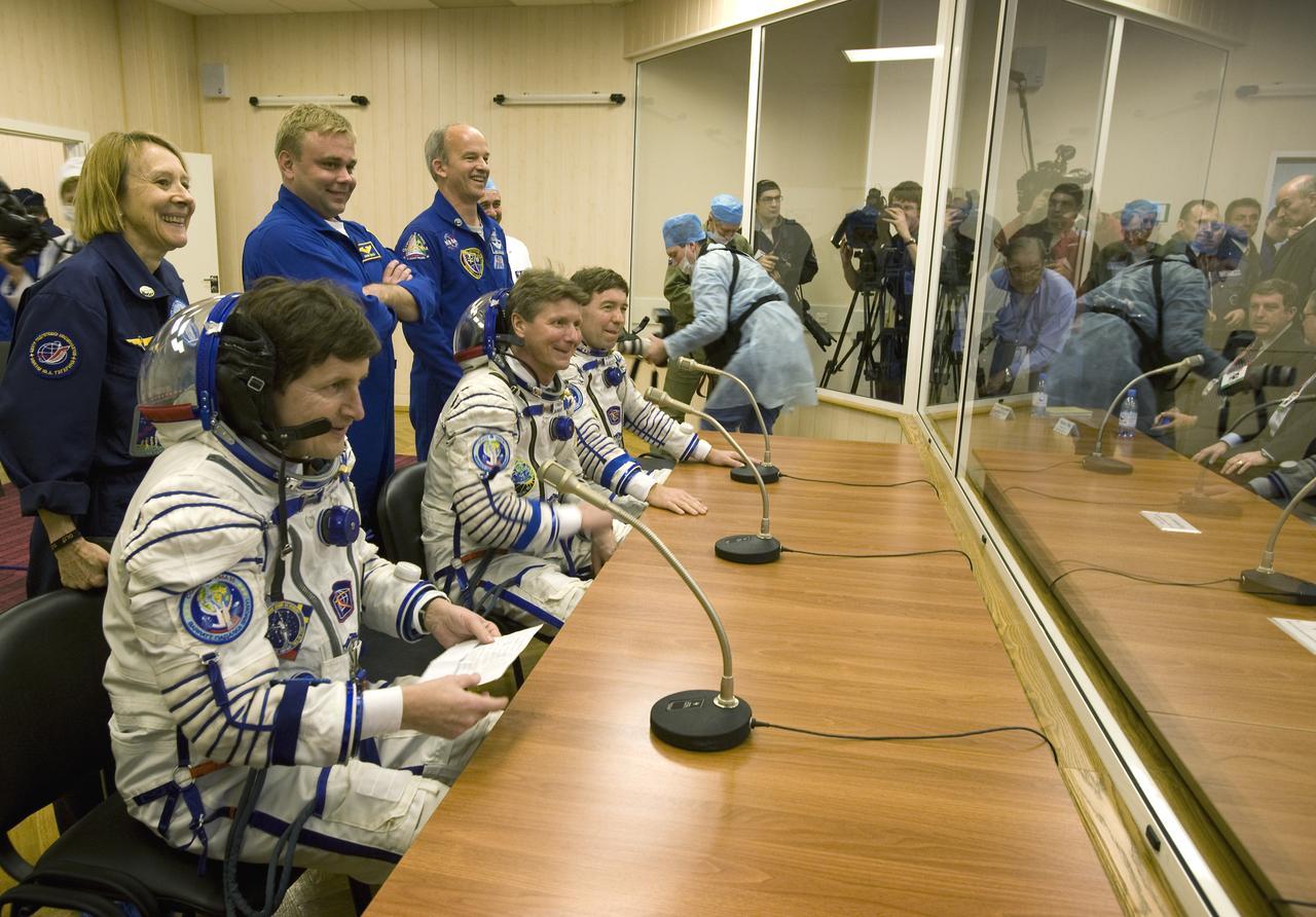Spaceflight Participant Charles Simonyi, seated left, Expedition 19 Commander Gennady I. Padalka, seated center, Flight Engineer Michael R. Barratt, seated right, backup spaceflight participant Esther Dyson, standing left, backup Expedition 19 flight engineer Maxim Suraev, standing center, and backup commander Jeffrey Williams prepare to talk with space agency officials prior to the launch on Thursday, March 26, 2009 in Baikonur, Kazakhstan.  Photo Credit: (NASA/Bill Ingalls)